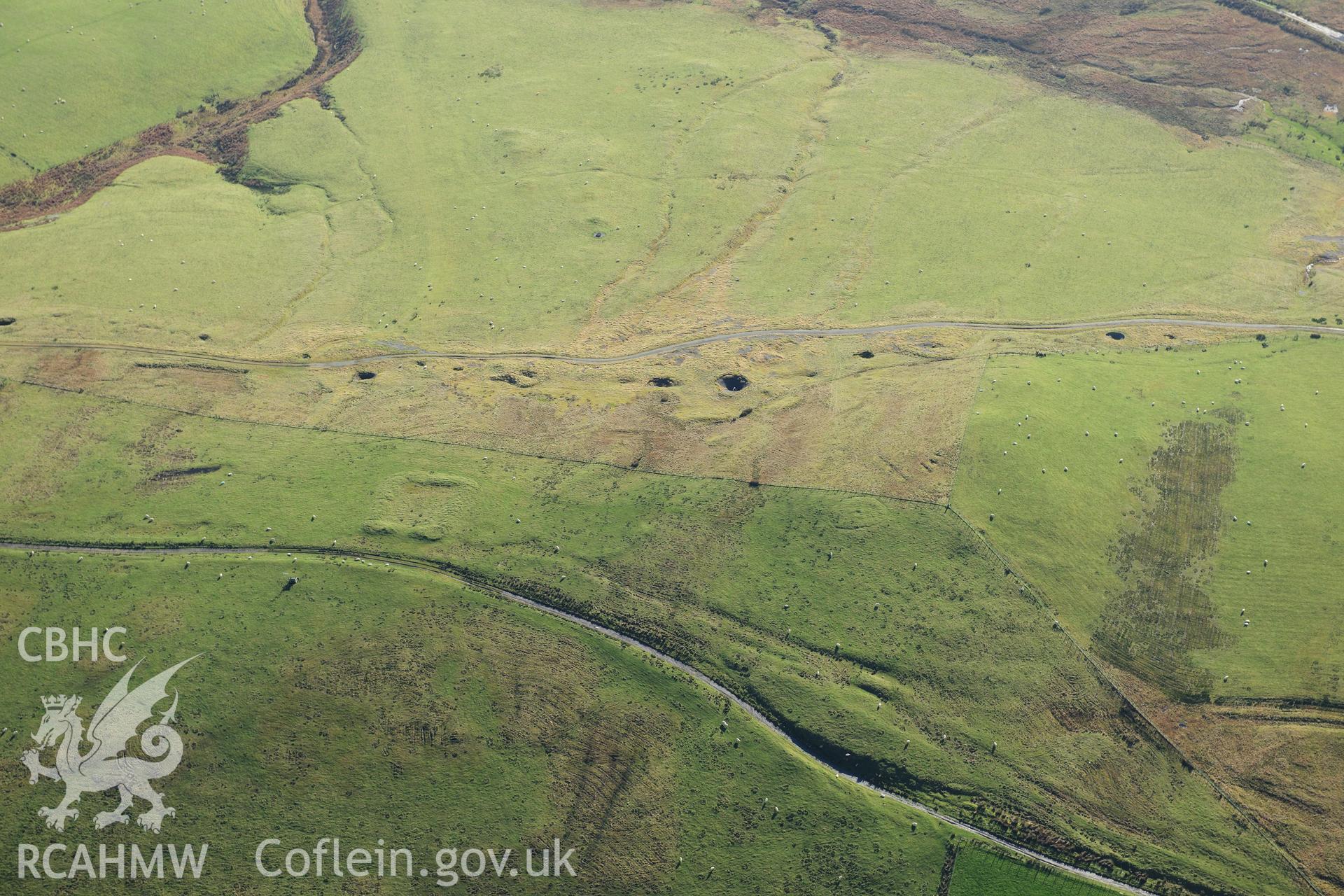 RCAHMW colour oblique photograph of Pen y crocbren Roman military site, with mines and round barrow, view from north. Taken by Toby Driver on 05/11/2012.