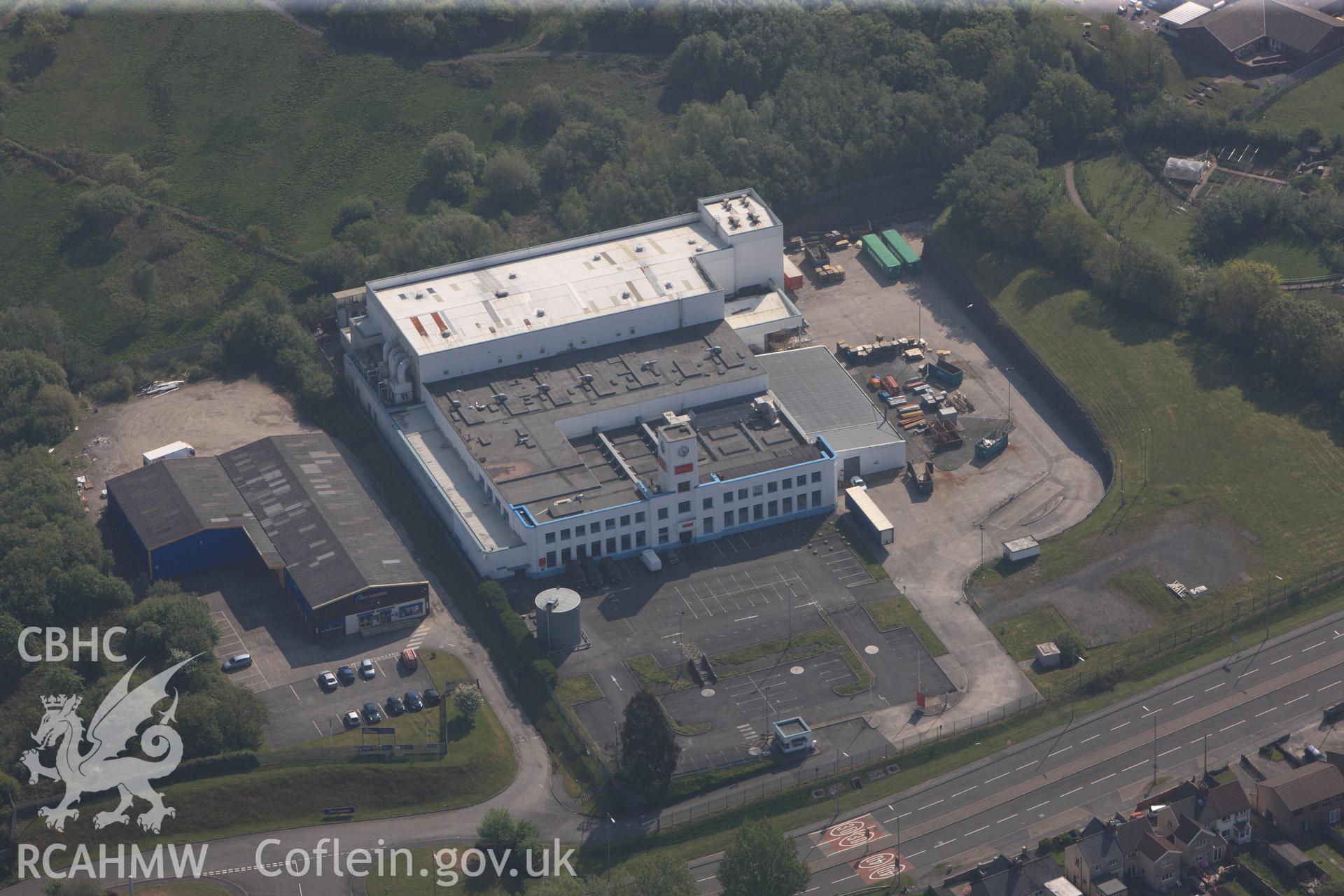 RCAHMW colour oblique photograph of General view of former Walkers Crisps factory, looking east. Taken by Toby Driver on 24/05/2012.