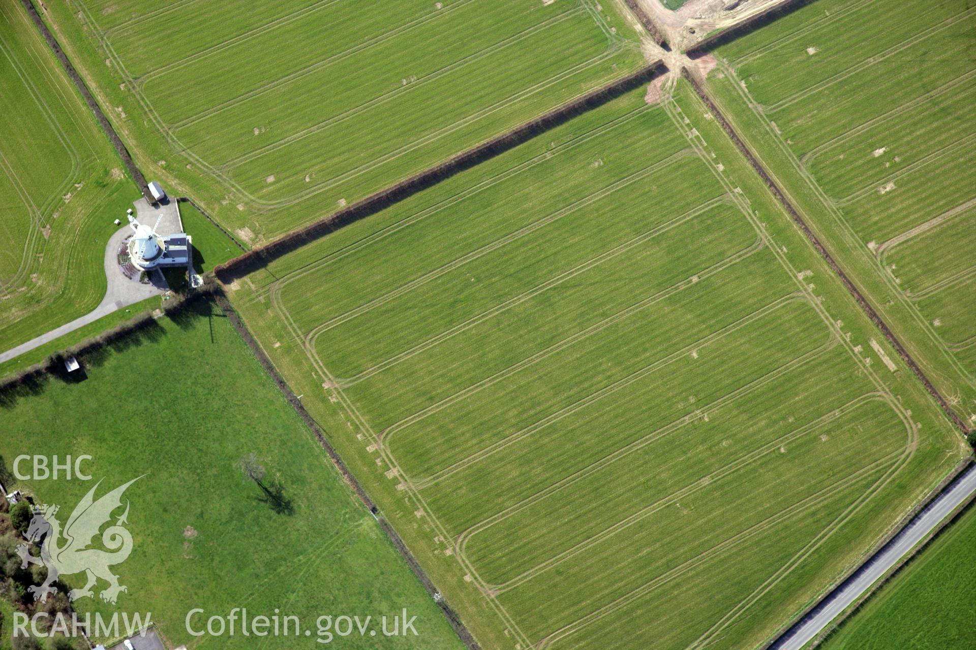 RCAHMW colour oblique photograph of Llancayo Farm Roman marching camp, and site of temple; cropmarks showing east side of camp and barrow cemetery. Taken by Toby Driver and Oliver Davies on 28/03/2012.