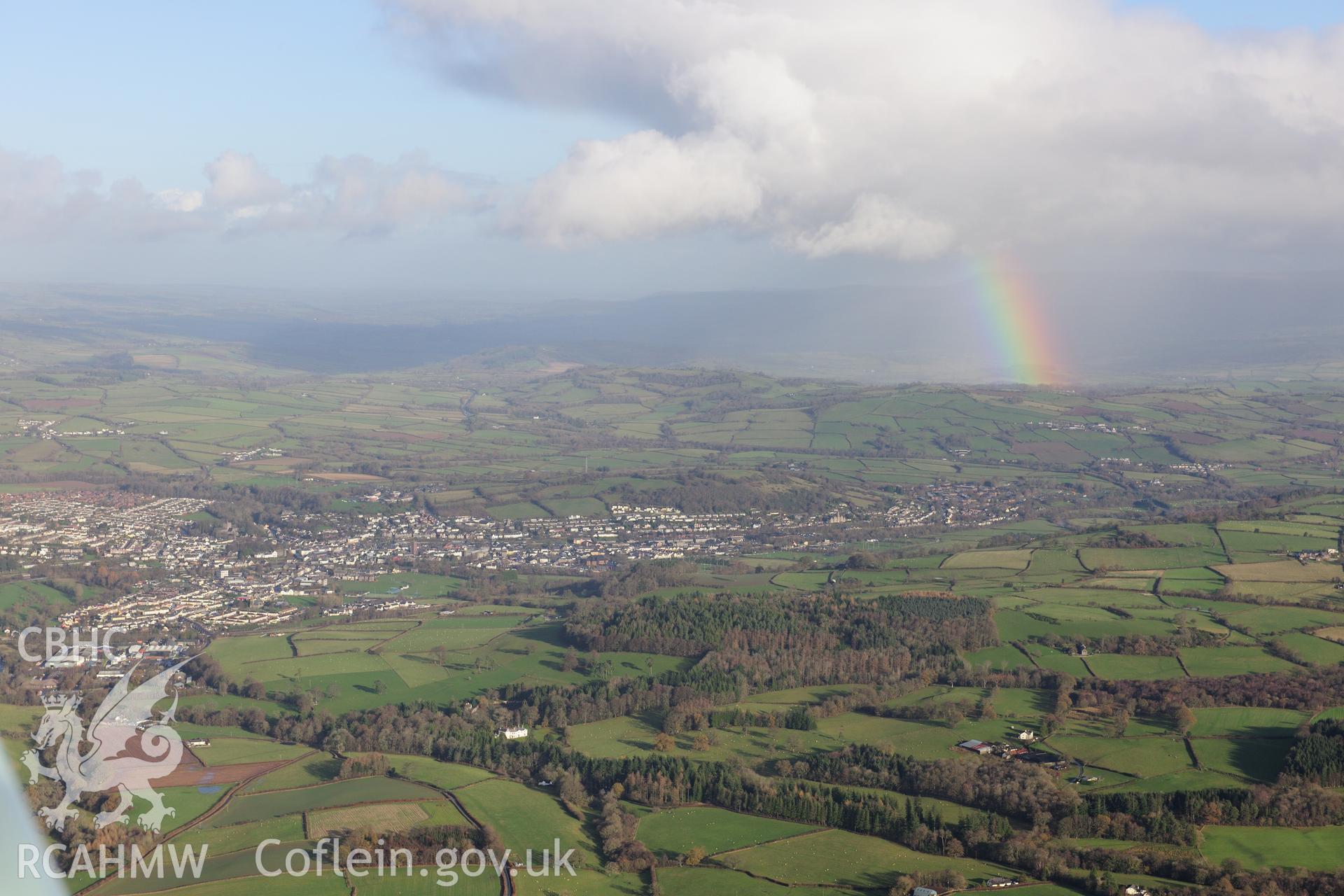 RCAHMW colour oblique photograph of Brecon, distant townscape from south-west over Held Wood, with rainbow. Taken by Toby Driver on 23/11/2012.