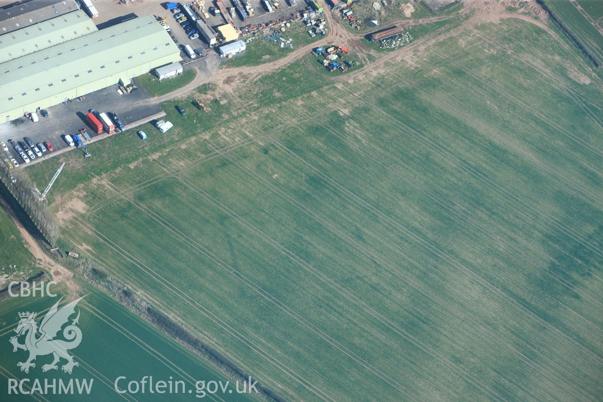 RCAHMW colour oblique photograph of Llancayo Farm defended enclosure cropmarks. Taken by Toby Driver and Oliver Davies on 28/03/2012.