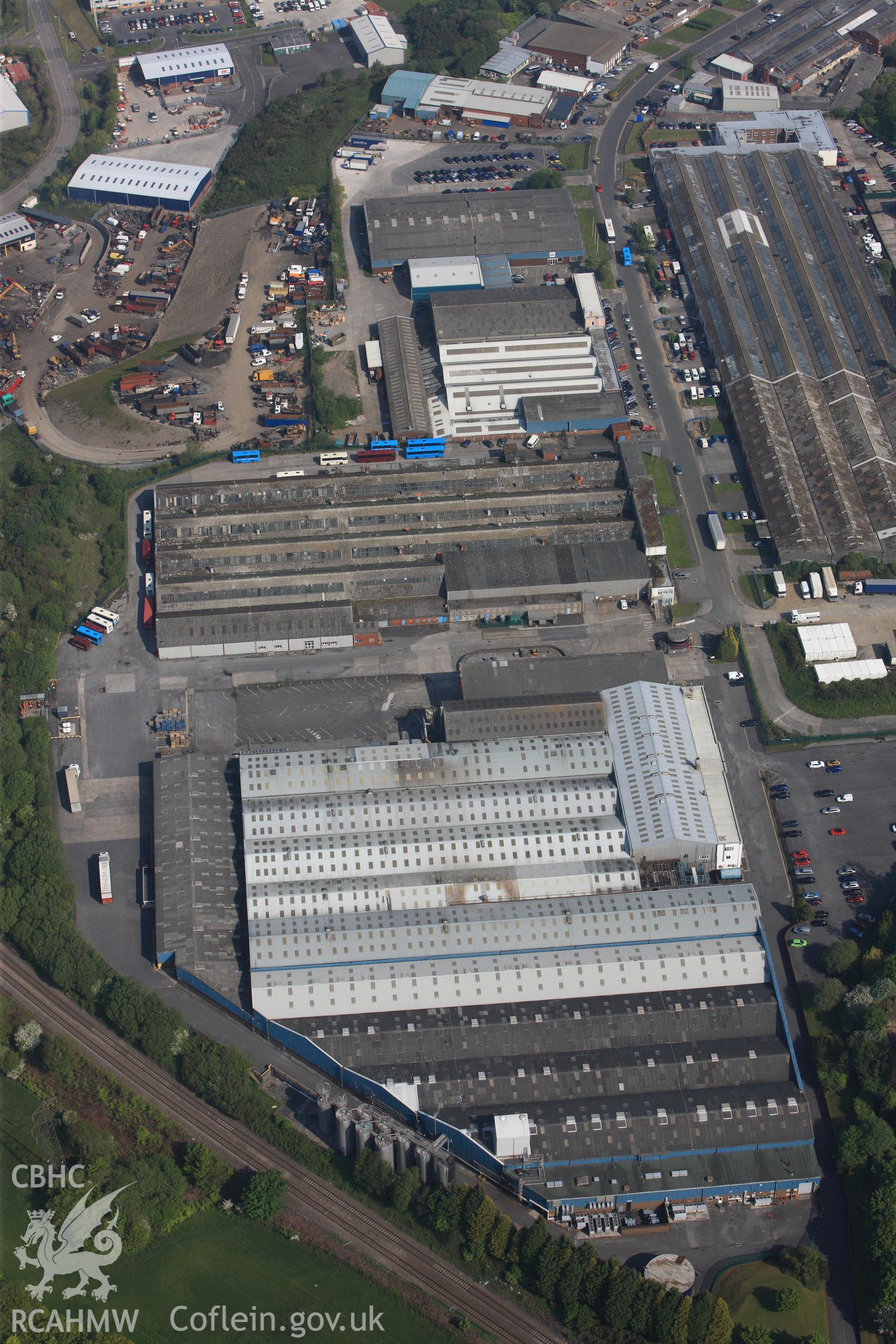 RCAHMW colour oblique photograph of General view of factories on Swansea West Industrial Estate looking north west towards former War Materials factory. Taken by Toby Driver on 24/05/2012.