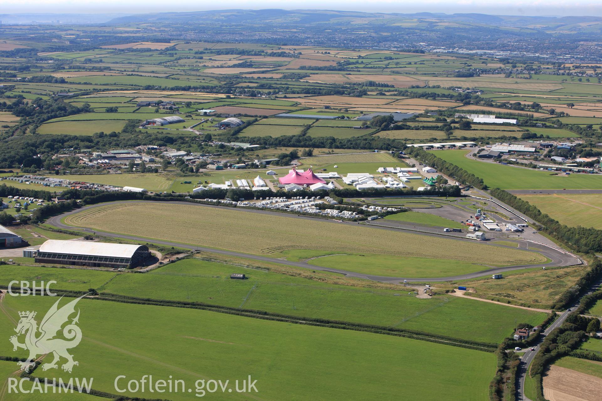 RCAHMW colour oblique photograph of Llandow Airfield, site of the 2012 National Eisteddfod of Wales. Taken by Toby Driver on 24/07/2012.