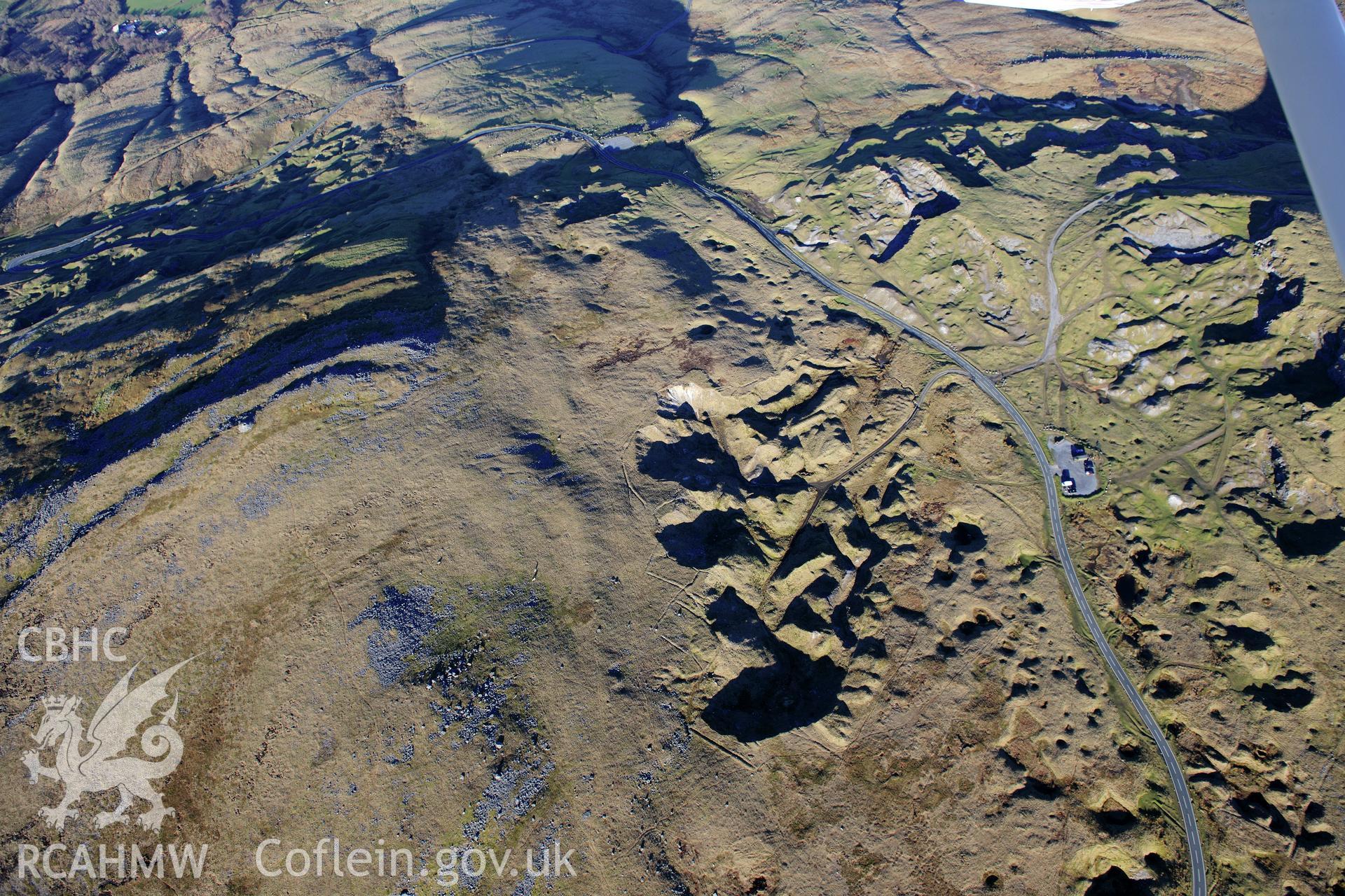 RCAHMW colour oblique photograph of Foel Fawr quarry complex, bank of quarries with feeder leats. Taken by Toby Driver on 28/11/2012.