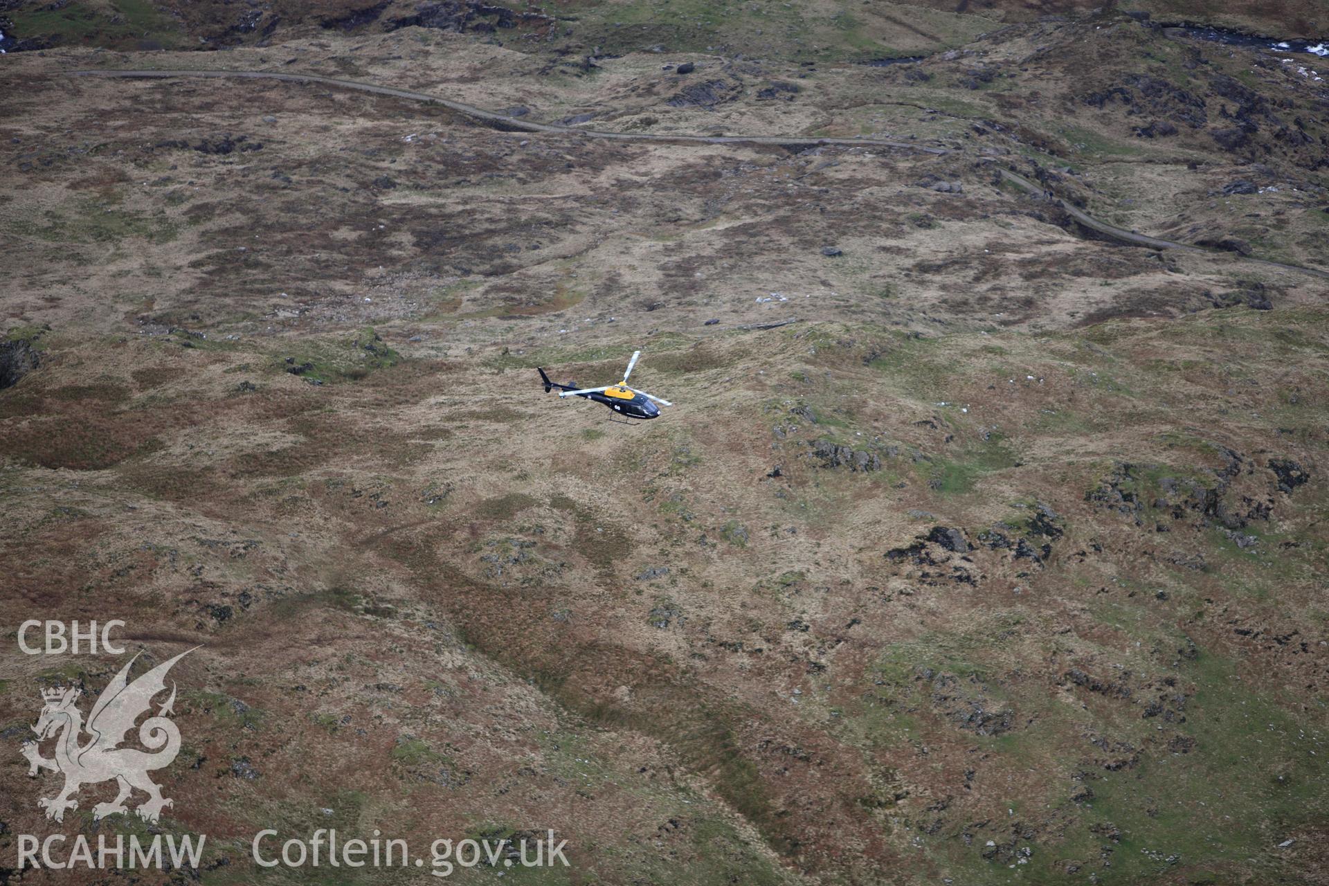 RCAHMW colour oblique photograph of RAF training helicopter above Hafod y Llan. Taken by Toby Driver on 13/01/2012.