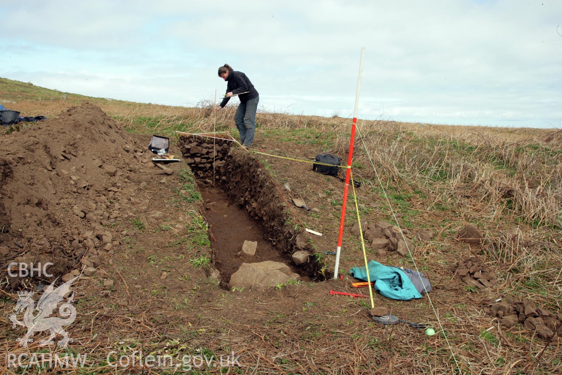 Skomer Island excavation of a burnt stone mound, Hut Group 8. Section drawing, view from the south-west