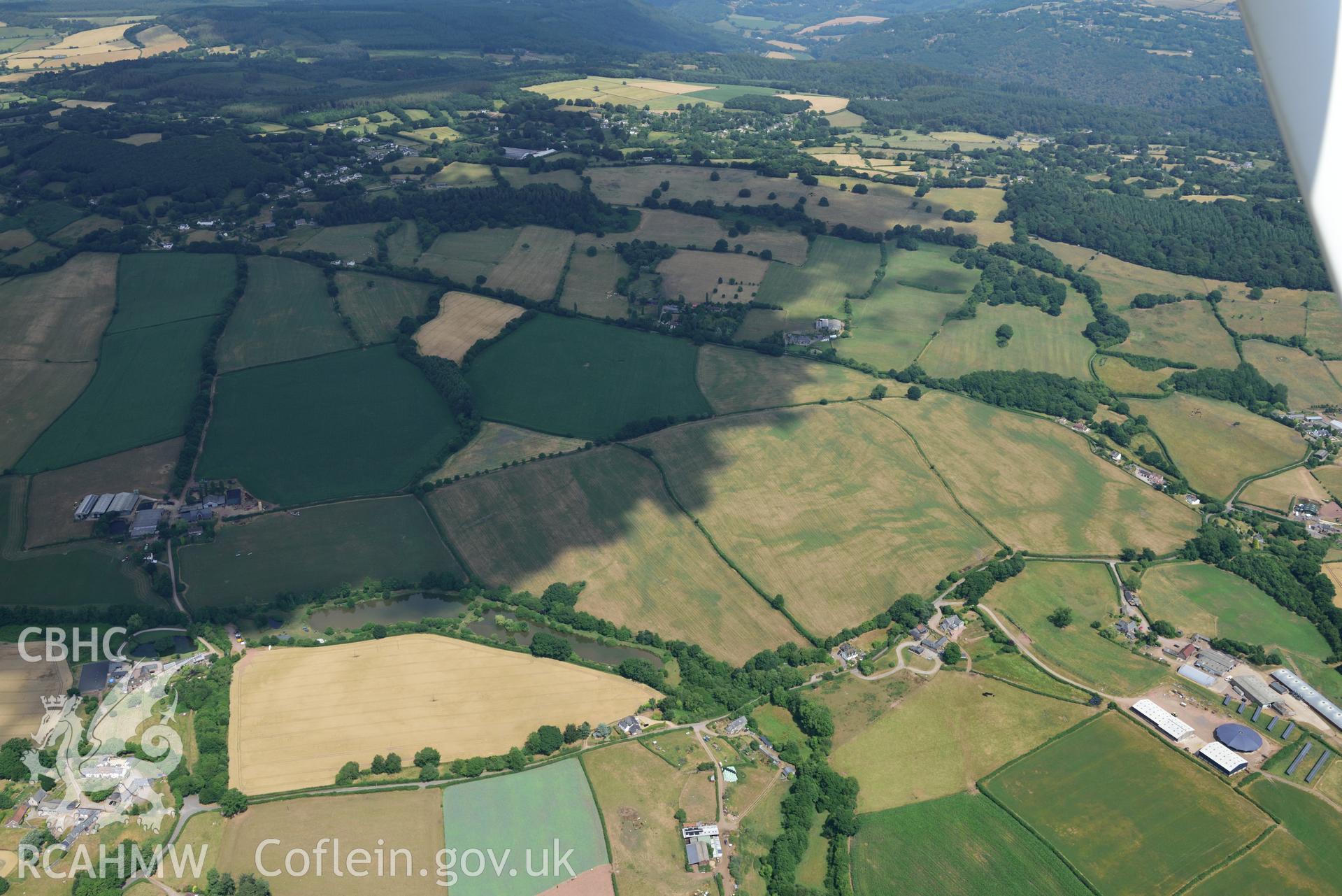 Royal Commission aerial photography of Trellech Grange, showing cropmarks northeast of Grange Spring Lakes at SO 496018, taken on 19th July 2018 during the 2018 drought.