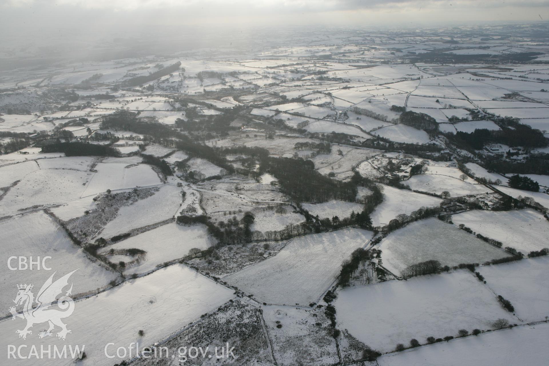 RCAHMW colour oblique photograph of Garreg Lwyd, defended enclosure, wide landscape. Taken by Toby Driver on 02/12/2010.