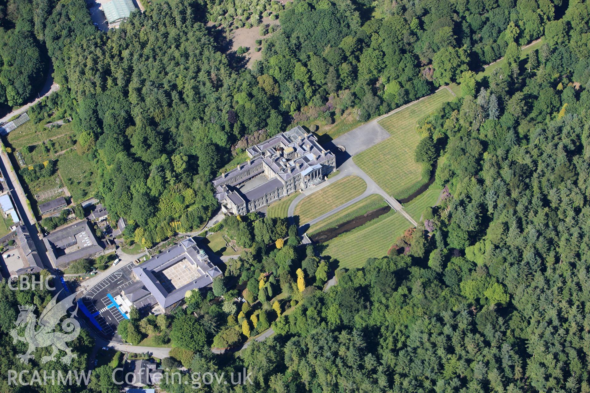 RCAHMW colour oblique photograph of Glynllifon Mansion, grounds and gardens. Taken by Toby Driver on 16/06/2010.