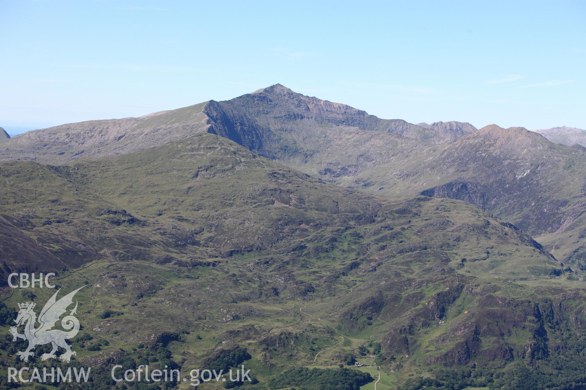 RCAHMW colour oblique photograph of Dinas Emrys Camp with Snowdon behind. Taken by Toby Driver on 16/06/2010.