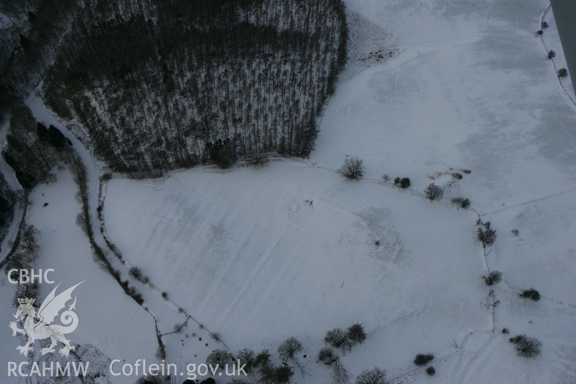 RCAHMW colour oblique photograph of Pantyfedwen enclosure, with traces of medieval strip fields. Taken by Toby Driver on 02/12/2010.