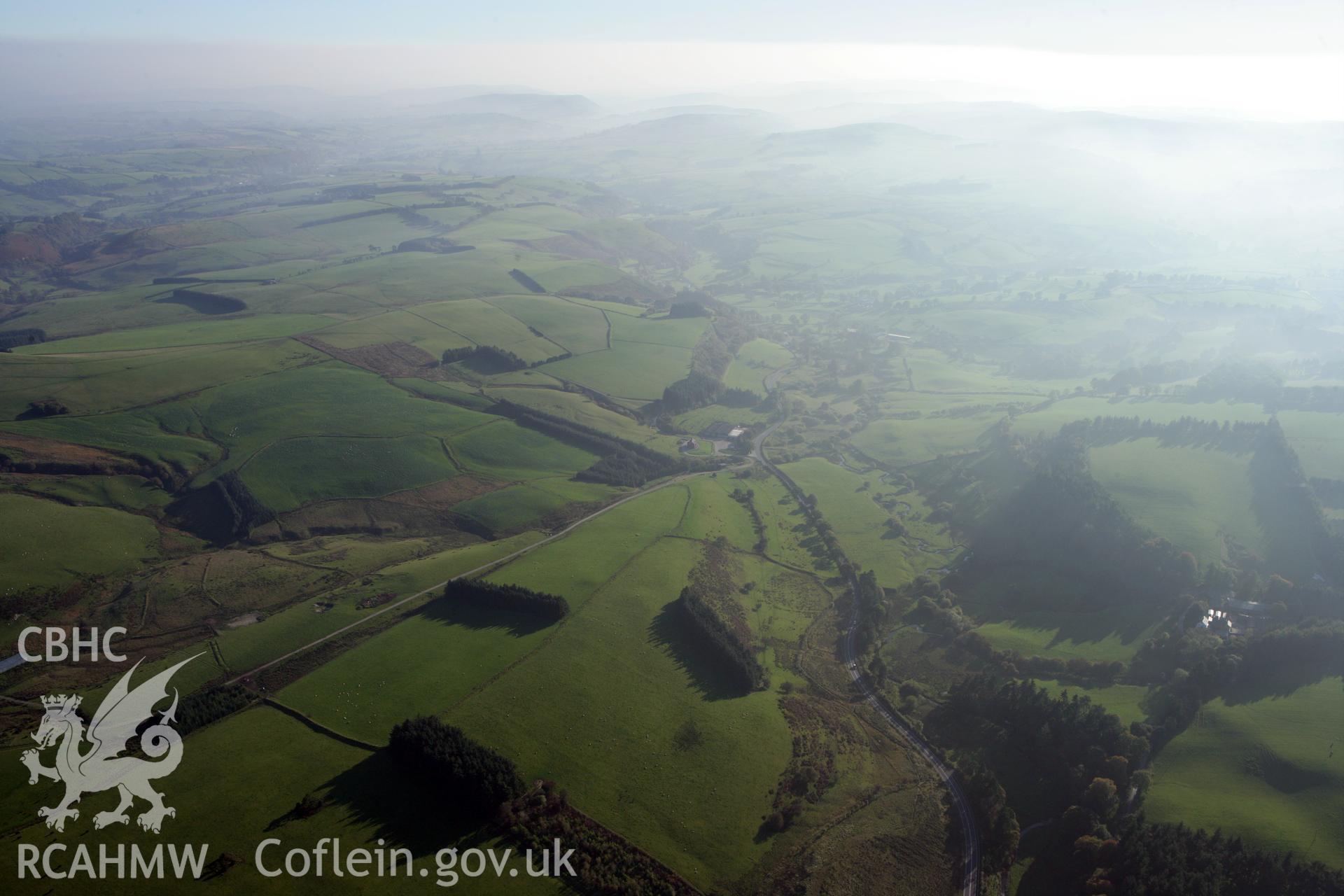 RCAHMW colour oblique photograph of Esgair-Draenllwyn Farm and landscape looking south. Taken by Toby Driver on 13/10/2010.