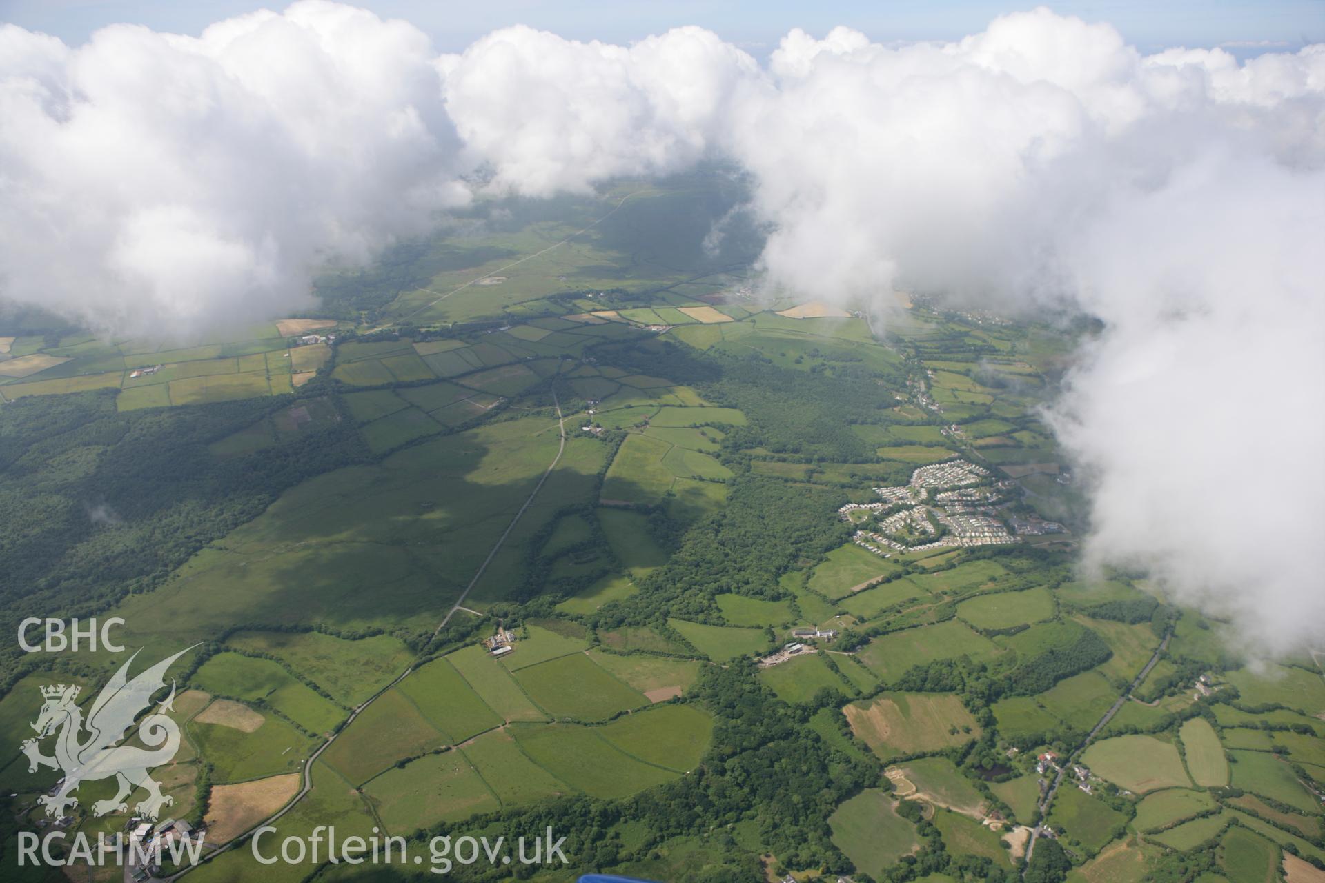 RCAHMW colour oblique photograph of Wern-halog caravan site, from the east, with Llanrhidian village beyond. Taken by Toby Driver on 22/06/2010.