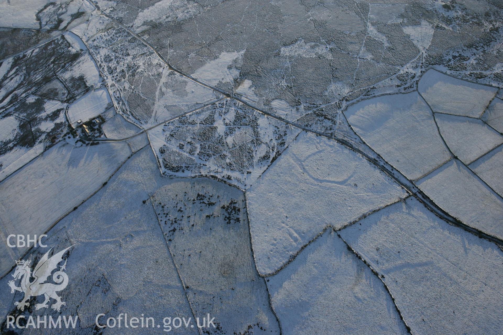 RCAHMW colour oblique photograph of Mynydd Dinas circular enclosure. Taken by Toby Driver on 01/12/2010.