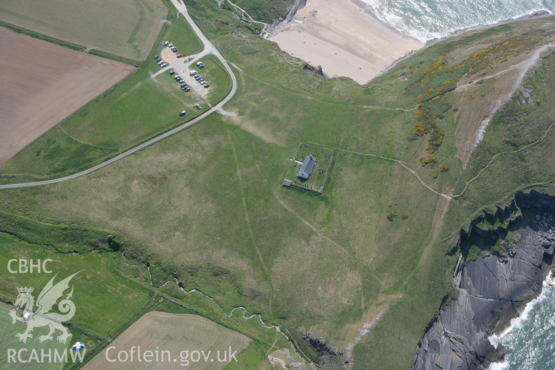 RCAHMW colour oblique photograph of Mwnt, promontory fort and church. Taken by Toby Driver on 25/05/2010.