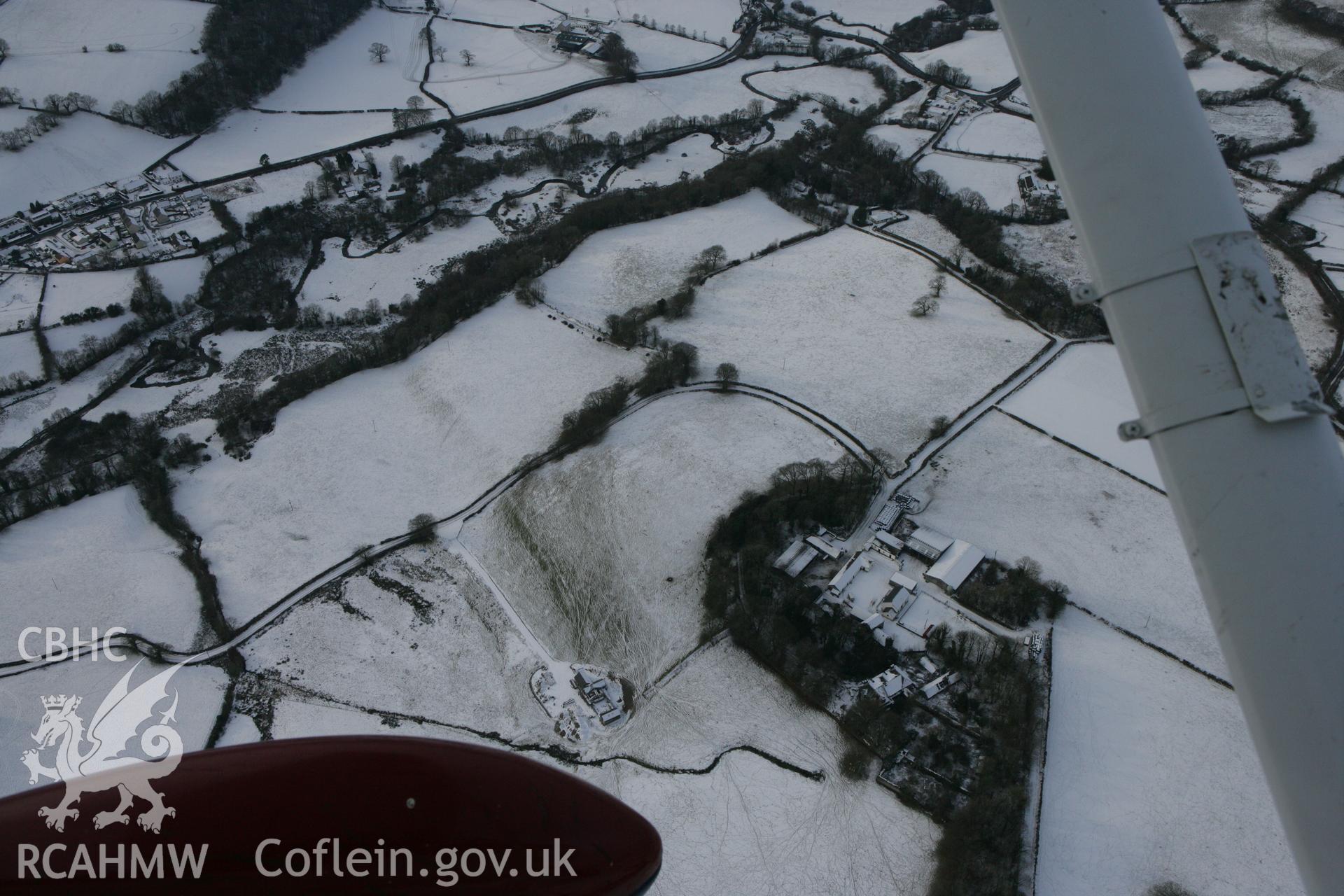 RCAHMW colour oblique photograph of Neuadd-fawr, possible curving earthwork of garden landscaping. Taken by Toby Driver on 02/12/2010.