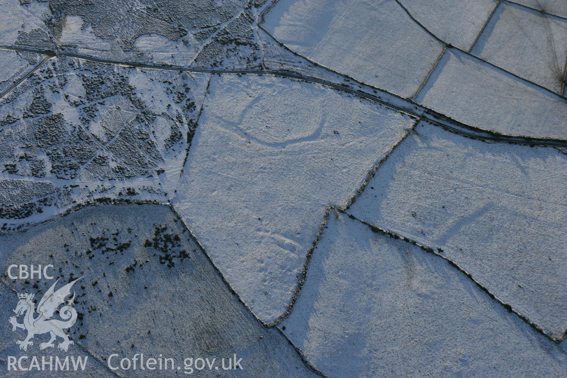 RCAHMW colour oblique photograph of Mynydd Dinas circular enclosure. Taken by Toby Driver on 01/12/2010.