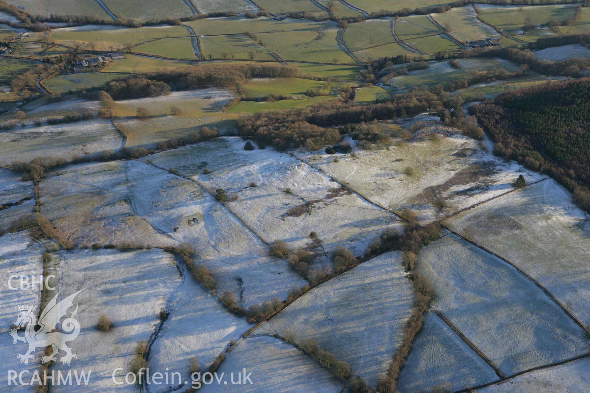RCAHMW colour oblique photograph of Allt Llwynmeredydd enclosure and avenue earthworks. Taken by Toby Driver on 08/12/2010.