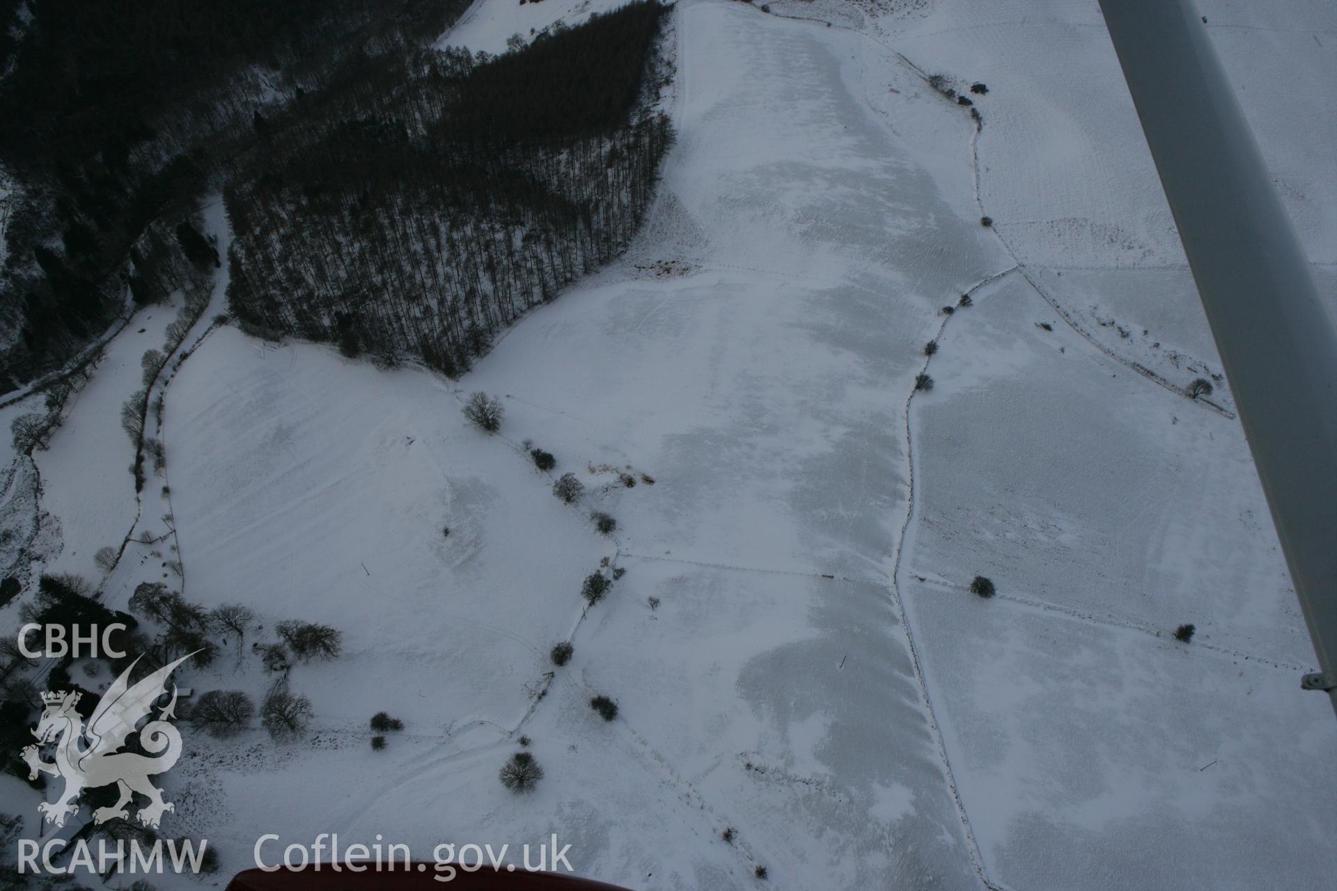 RCAHMW colour oblique photograph of Pantyfedwen enclosure, with traces of medieval strip fields. Taken by Toby Driver on 02/12/2010.