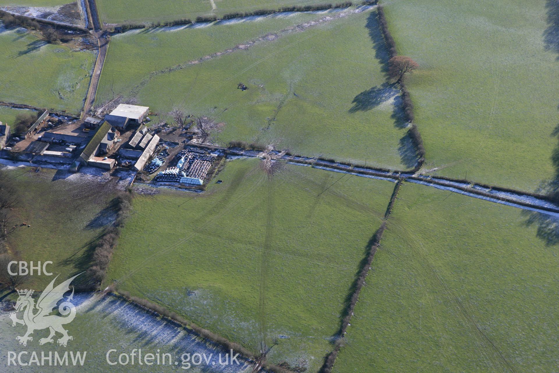 RCAHMW colour oblique photograph of Pentrebane, with low earthworks. Taken by Toby Driver on 08/12/2010.