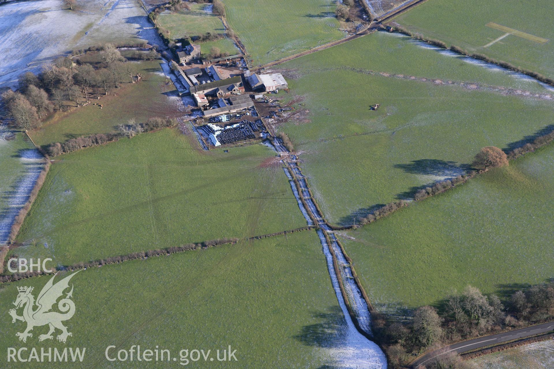 RCAHMW colour oblique photograph of Pentrebane, with low earthworks. Taken by Toby Driver on 08/12/2010.