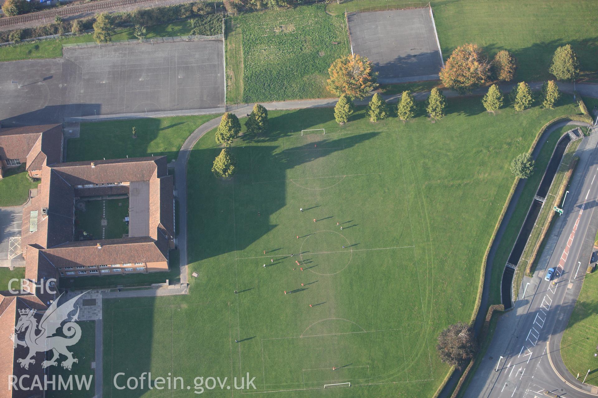 RCAHMW colour oblique photograph of Football match at the Royal Artillery Camp, Llandrindod Road, Newtown. Taken by Toby Driver on 13/10/2010.