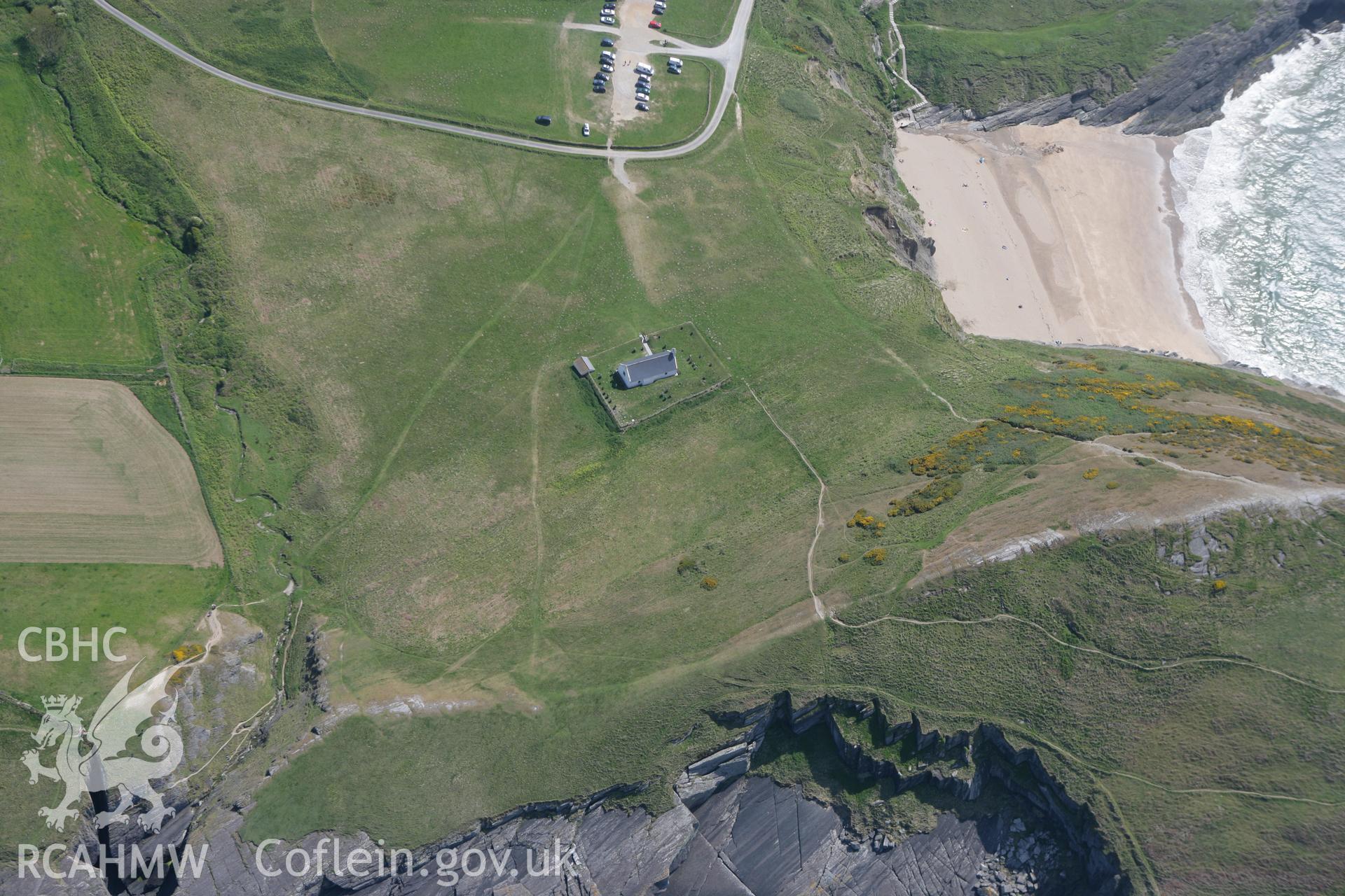 RCAHMW colour oblique photograph of Mwnt, promontory fort and church. Taken by Toby Driver on 25/05/2010.