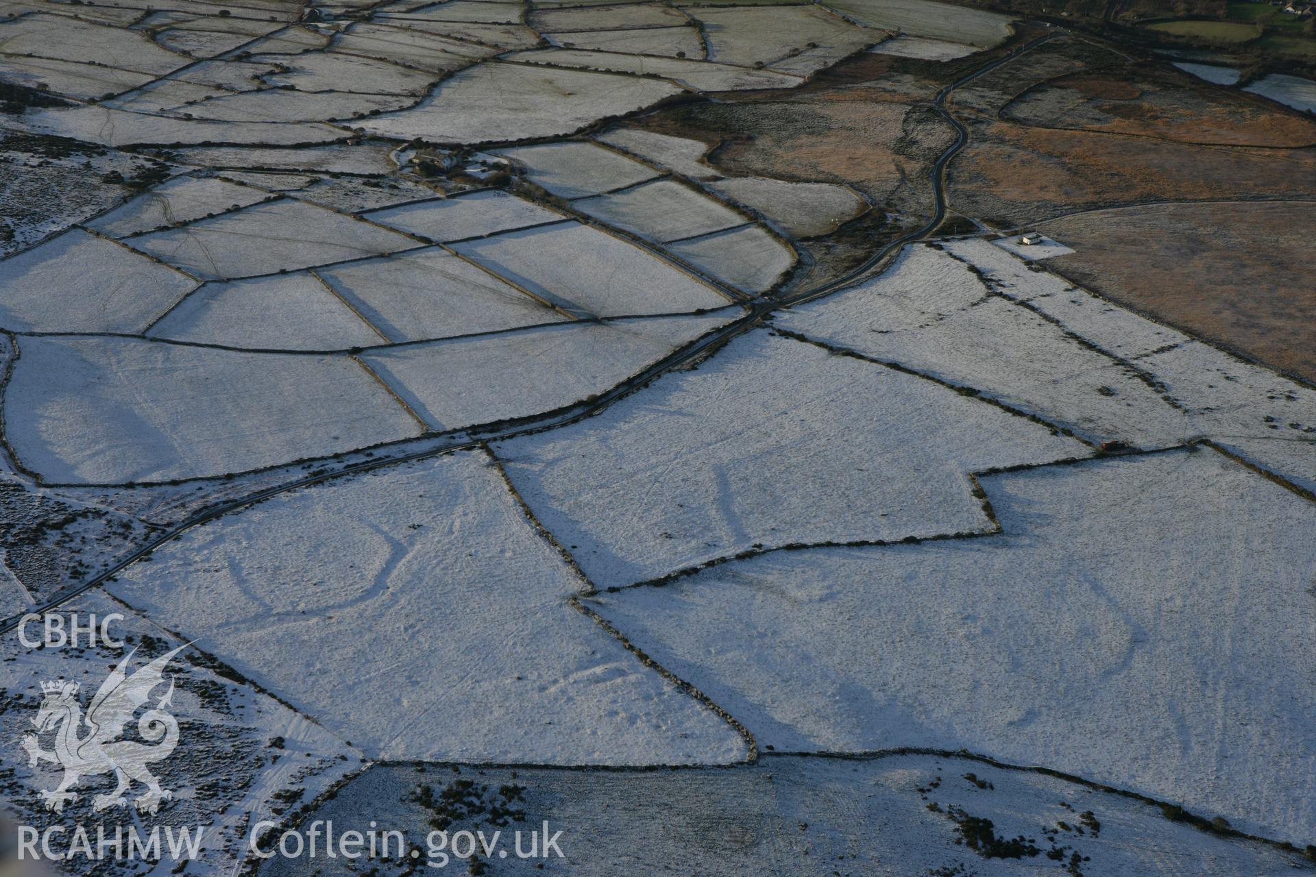 RCAHMW colour oblique photograph of Mynydd Dinas circular enclosure. Taken by Toby Driver on 01/12/2010.