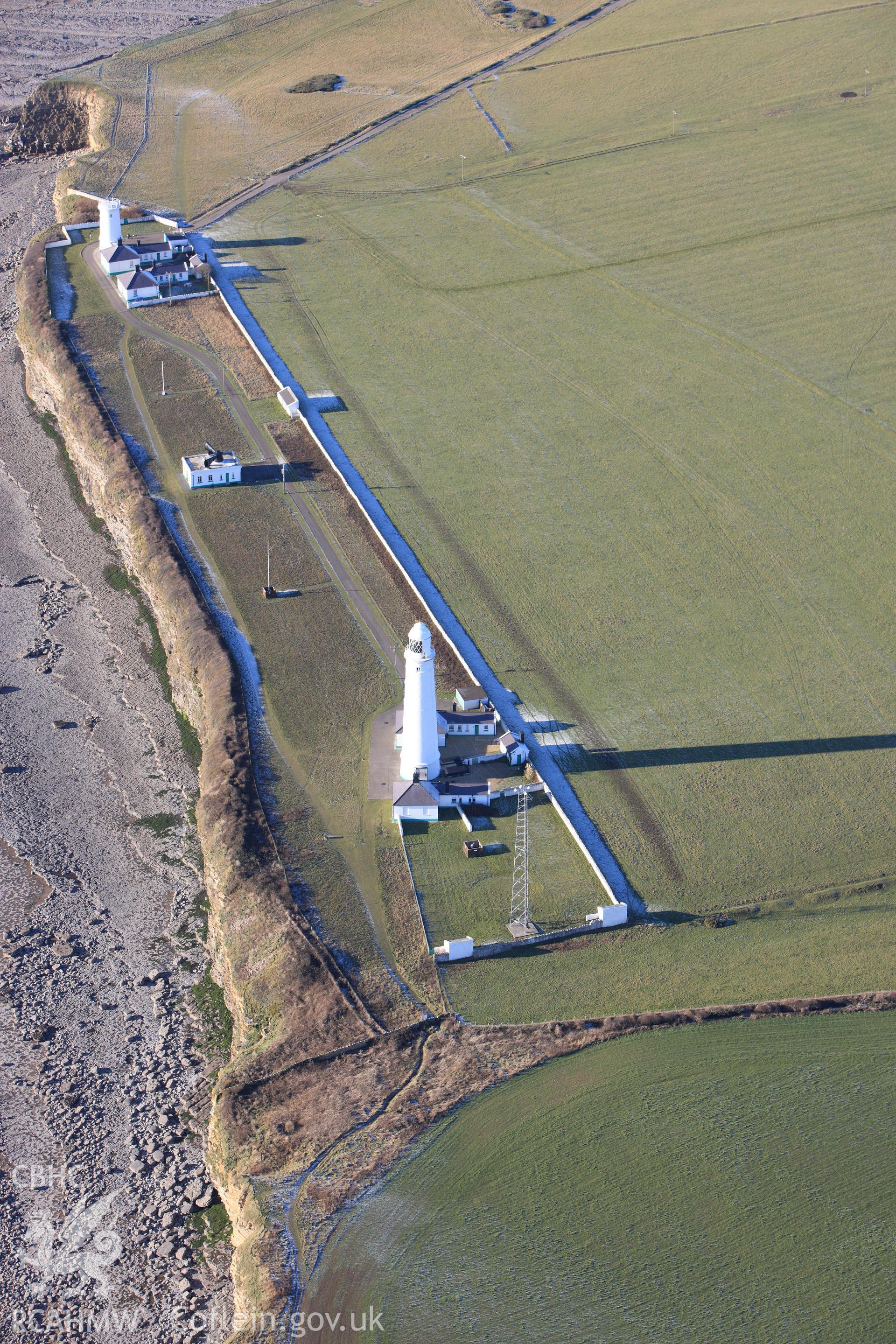 RCAHMW colour oblique photograph of Nash point lighthouse, showing east and west towers and the foghorn signal building. Taken by Toby Driver on 08/12/2010.