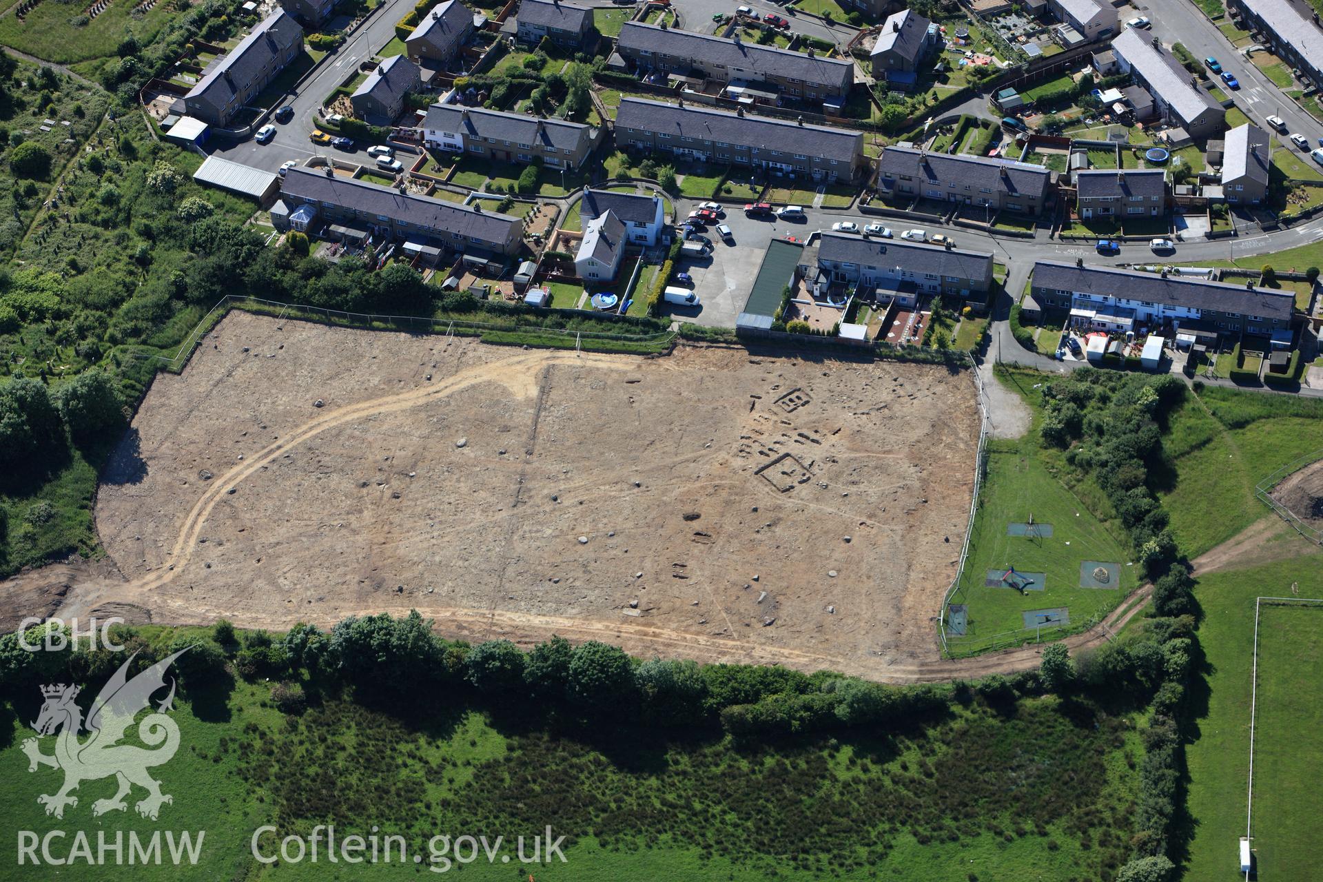 RCAHMW colour oblique photograph of Tyddyn Pandy Square Barrow Cemetery under excavation by Gwynedd Archaeological Trust. Taken by Toby Driver on 16/06/2010.