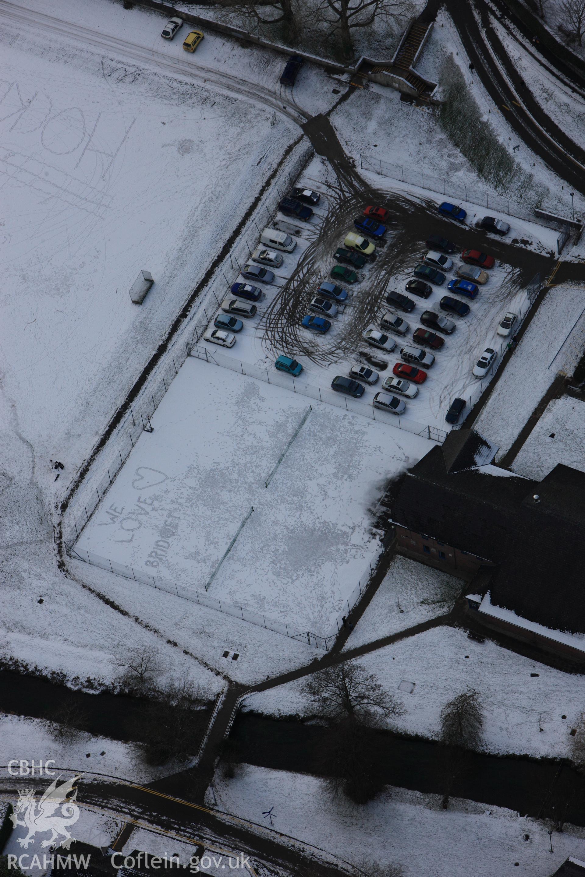 RCAHMW colour oblique photograph of Lampeter University, with names written in snow on hockey pitch. Taken by Toby Driver on 02/12/2010.