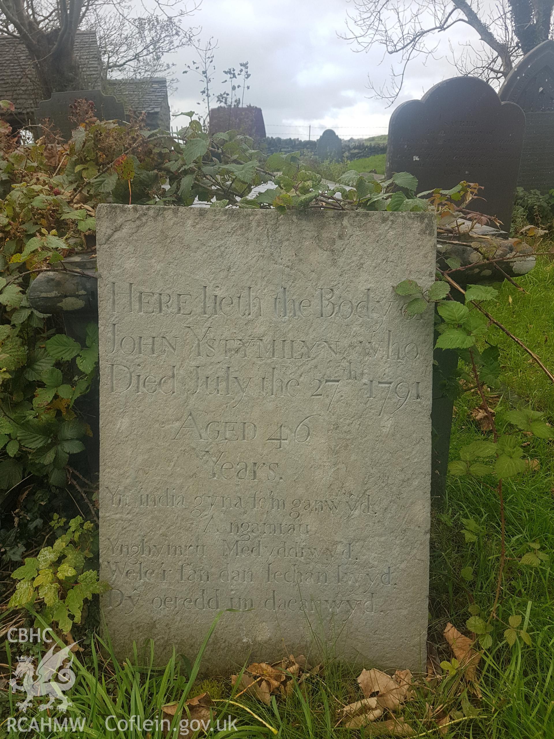 The gravestone of John Ystumllyn in St Cynhaearn's churchyard. Photographed by Helen Rowe of RCAHMW on 10th October 2020.