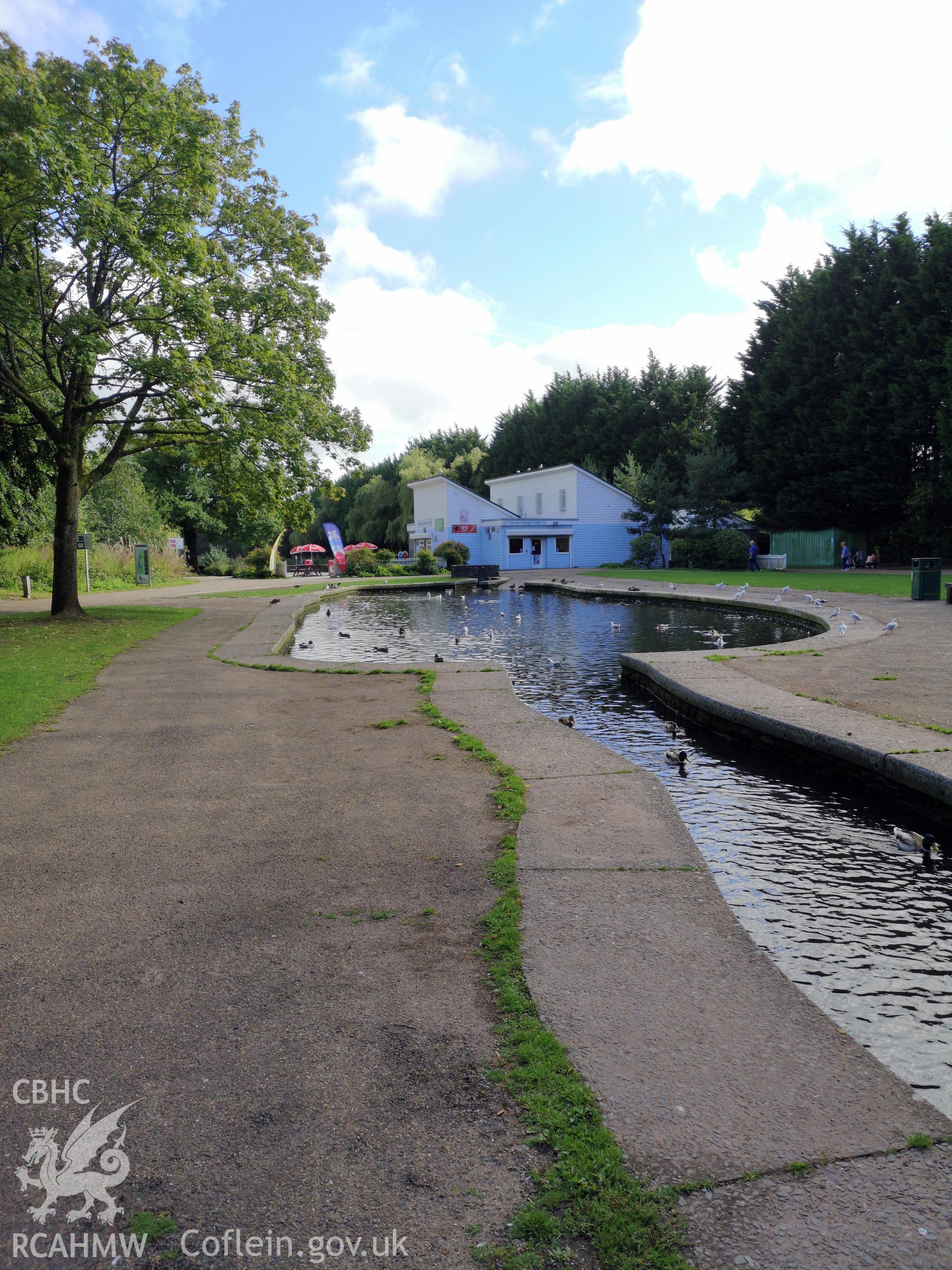 Ornamental running water feature with blue and white building beyond at Cwmbran Park, photographed by Susan Fielding of RCAHMW on 12 September 2019.