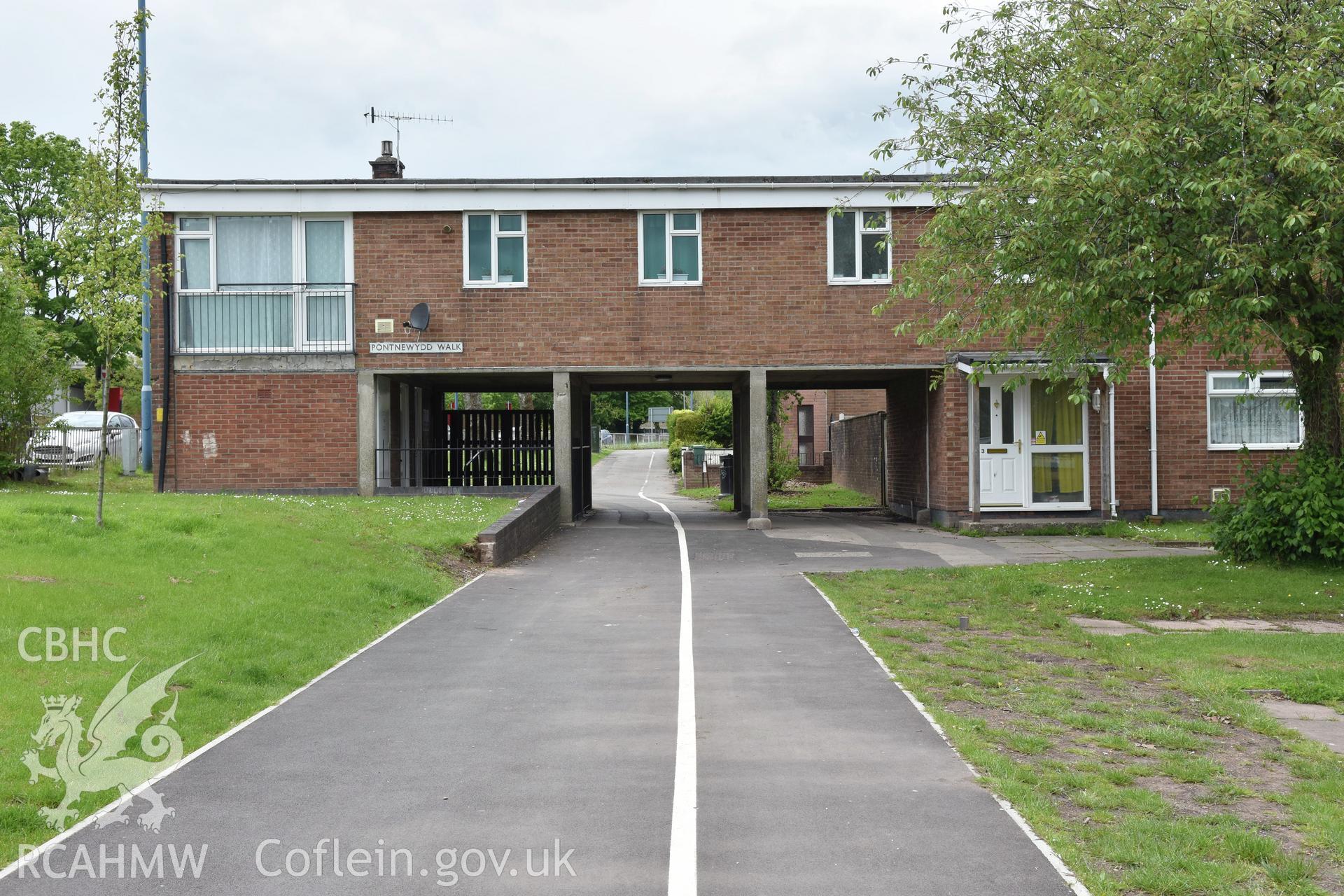 Exterior view of housing on Pontnewydd walk in Cwmbran town centre, with a cycle path underneath. Photographed by Susan Fielding of RCAHMW on 25 May 2021.