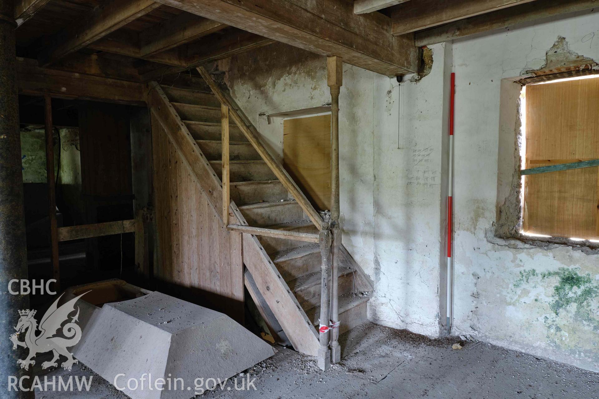 Colour photograph showing Blackpool Mill - 2nd floor, stair to 3rd floor, looking SE. Produced as part of Historic Building Recording for Blackpool Mill, carried out by Richard Hayman, June 2021.