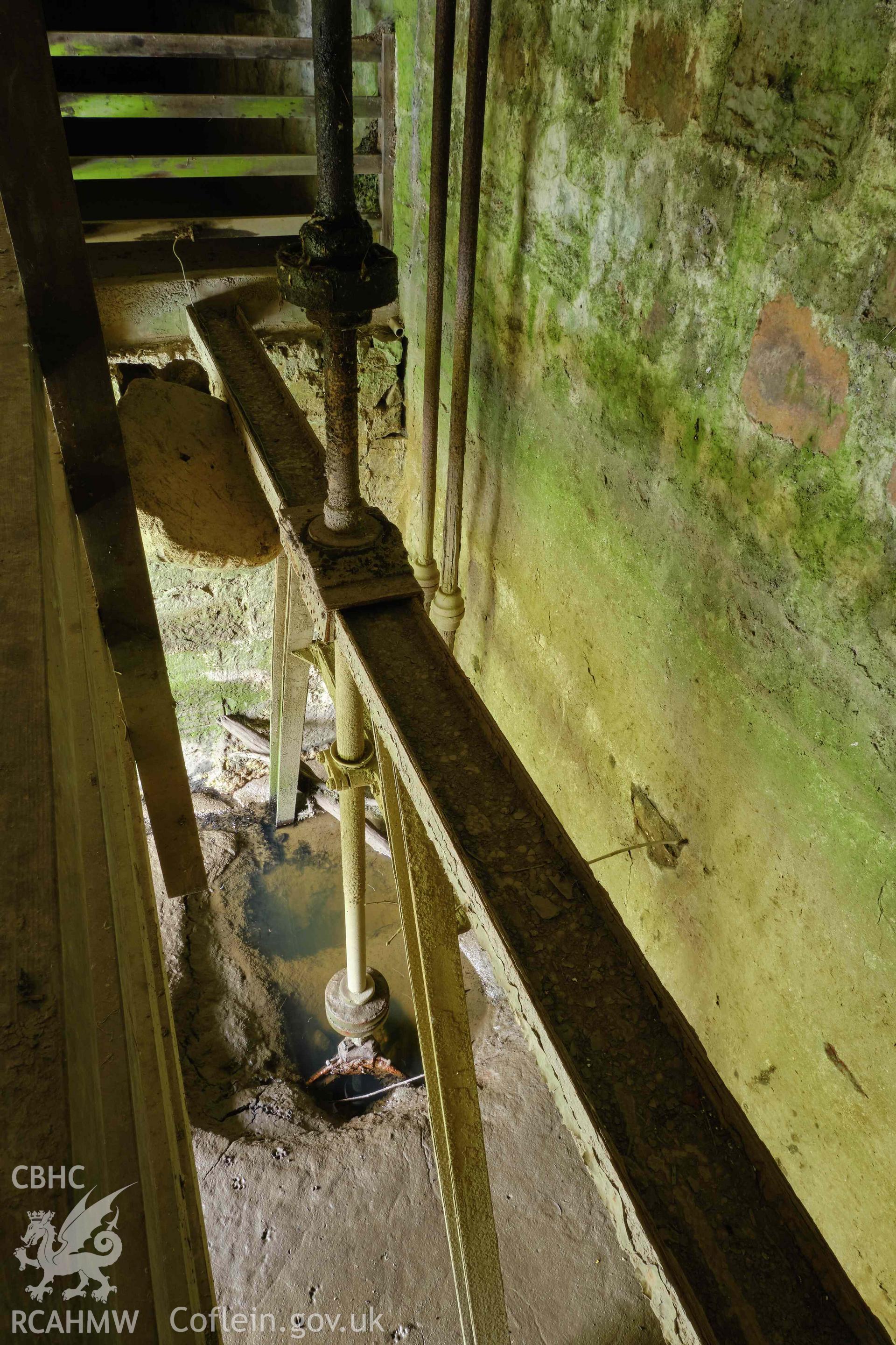 Colour photograph showing Blackpool Mill - basement, turbine shaft, looking E. Produced as part of Historic Building Recording for Blackpool Mill, carried out by Richard Hayman, June 2021.