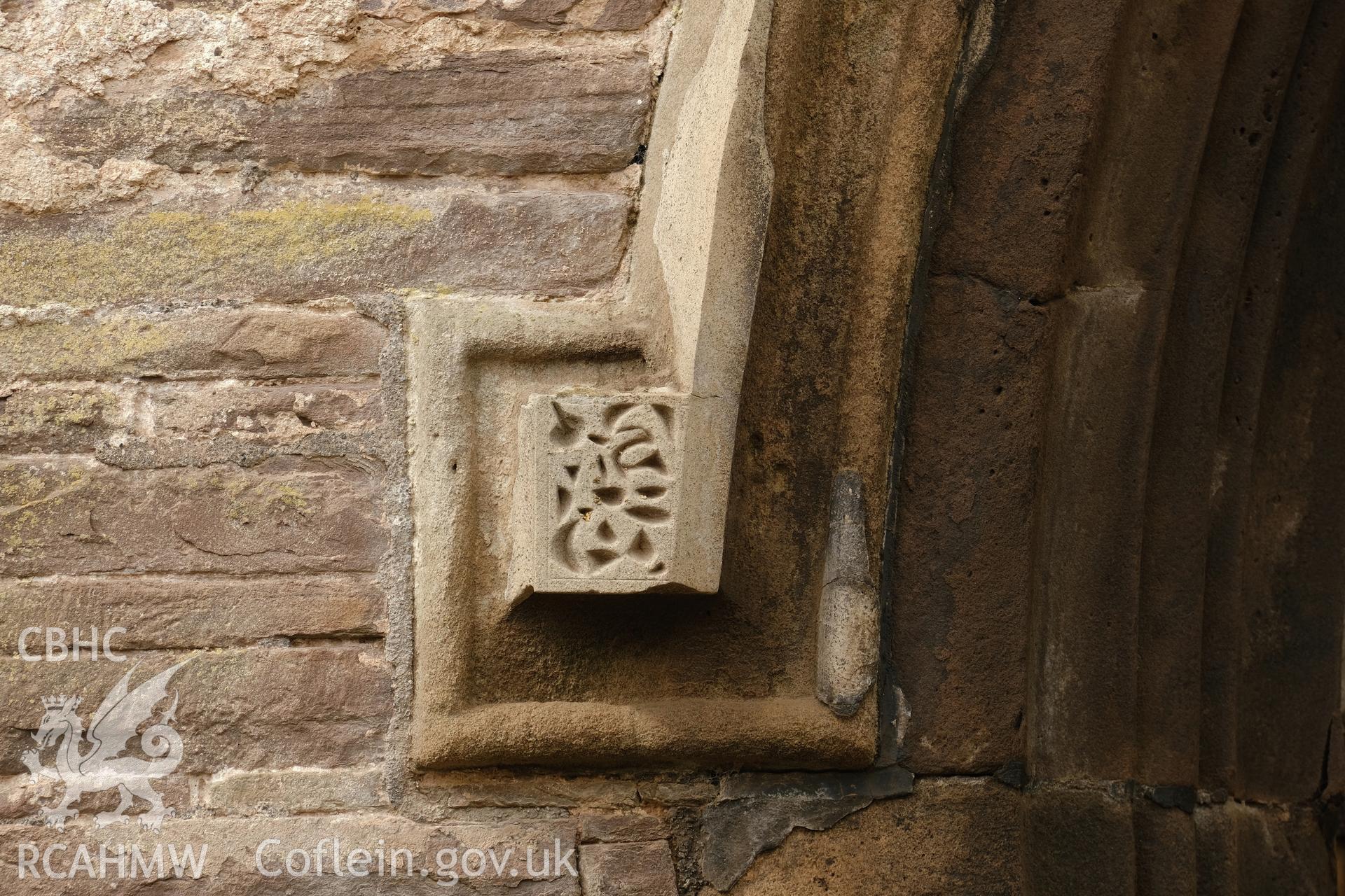 Colour photograph showing Great Porthmel Gatehouse - left-hand lable stop in arch to SE front. Produced as part of Historic Building Recording for Great Porthamel Gatehouse, carried out by Richard Hayman, April 2021.
