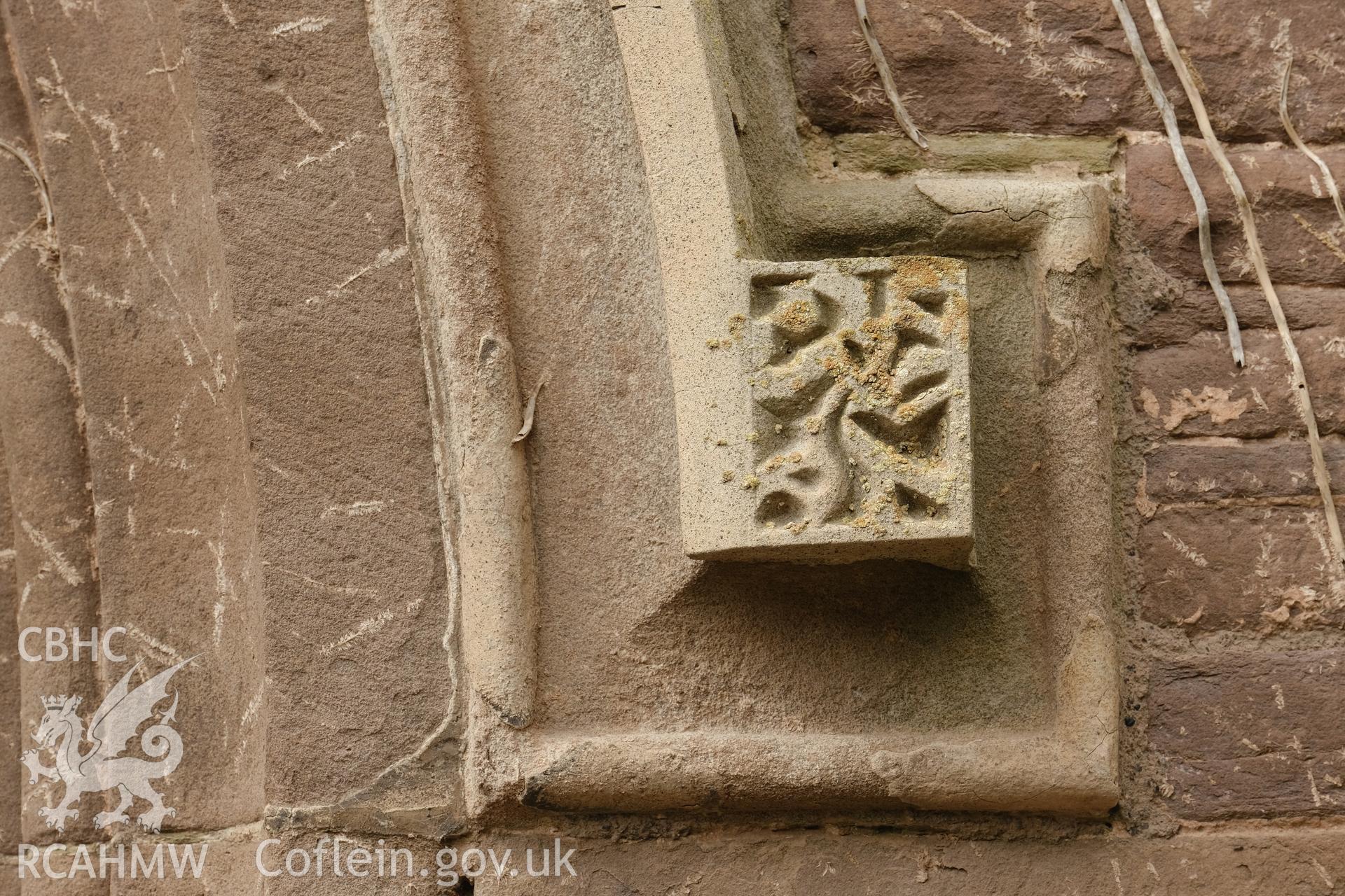 Colour photograph showing Great Porthmel Gatehouse - right-hand lable stop in arch to SE front. Produced as part of Historic Building Recording for Great Porthamel Gatehouse, carried out by Richard Hayman, April 2021.