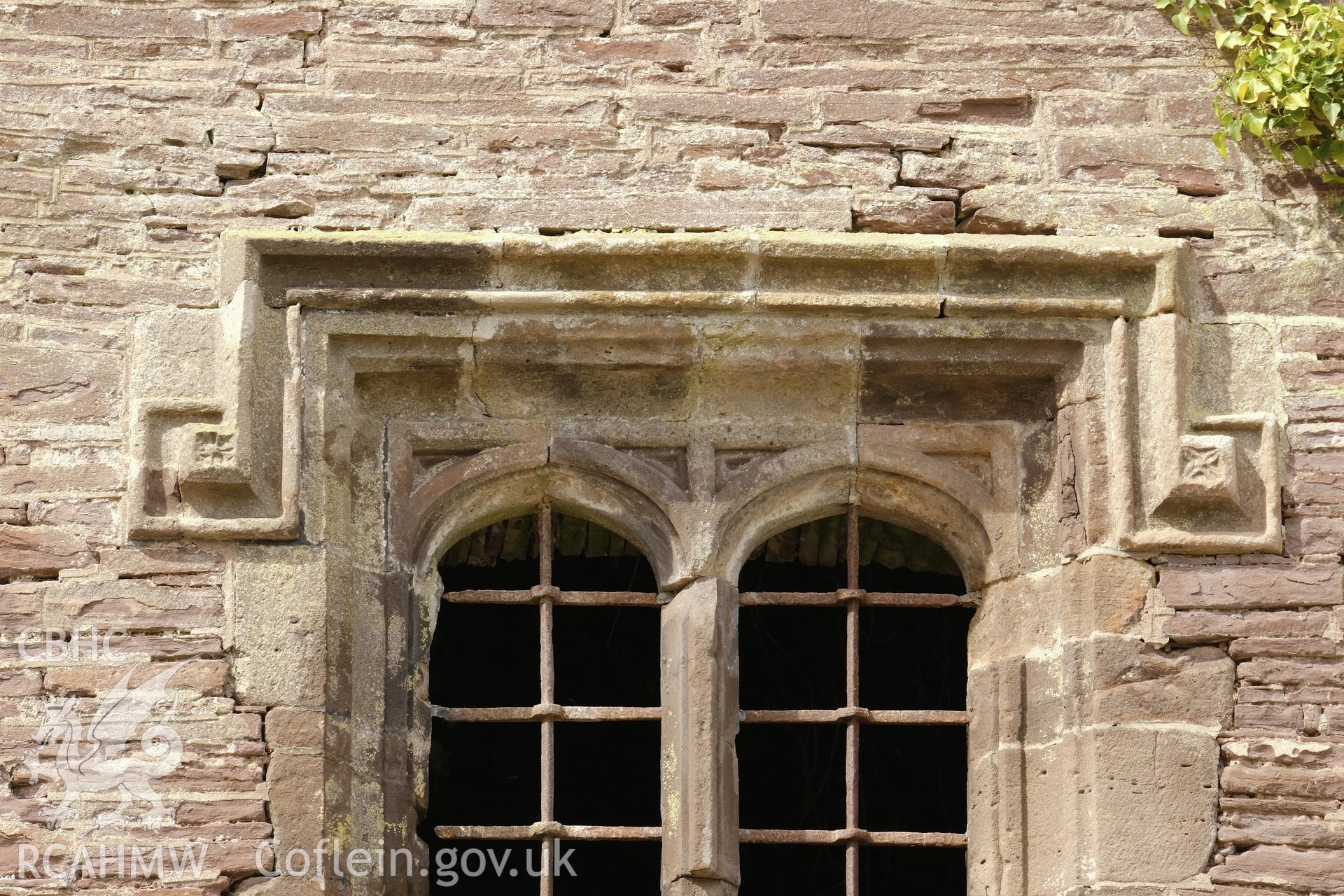 Colour photograph showing Great Porthmel Gatehouse - hood mould to upper-stage window in SE front. Produced as part of Historic Building Recording for Great Porthamel Gatehouse, carried out by Richard Hayman, April 2021.