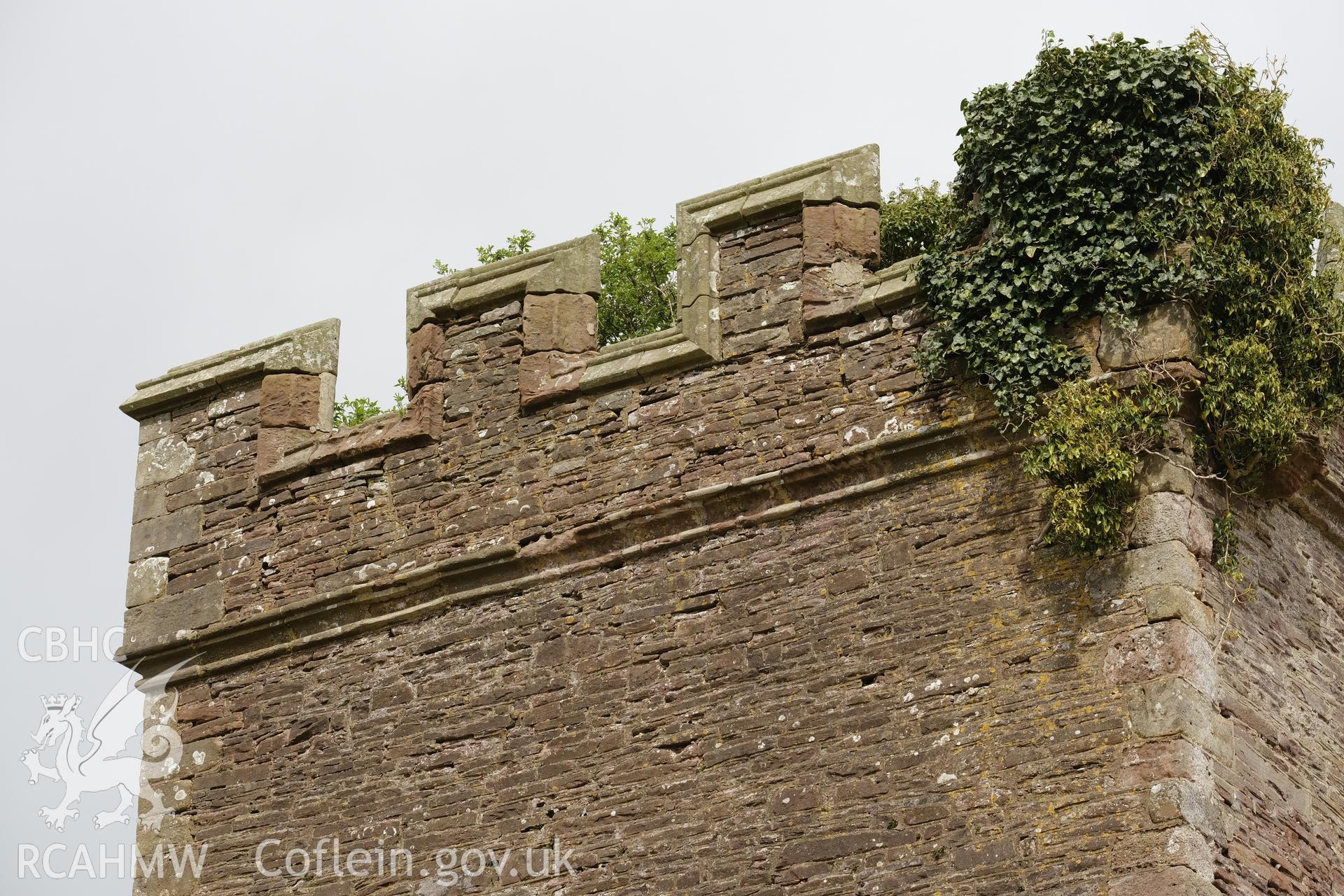 Colour photograph showing Great Porthmel Gatehouse - parapet in SW front, looking NW. Produced as part of Historic Building Recording for Great Porthamel Gatehouse, carried out by Richard Hayman, April 2021.