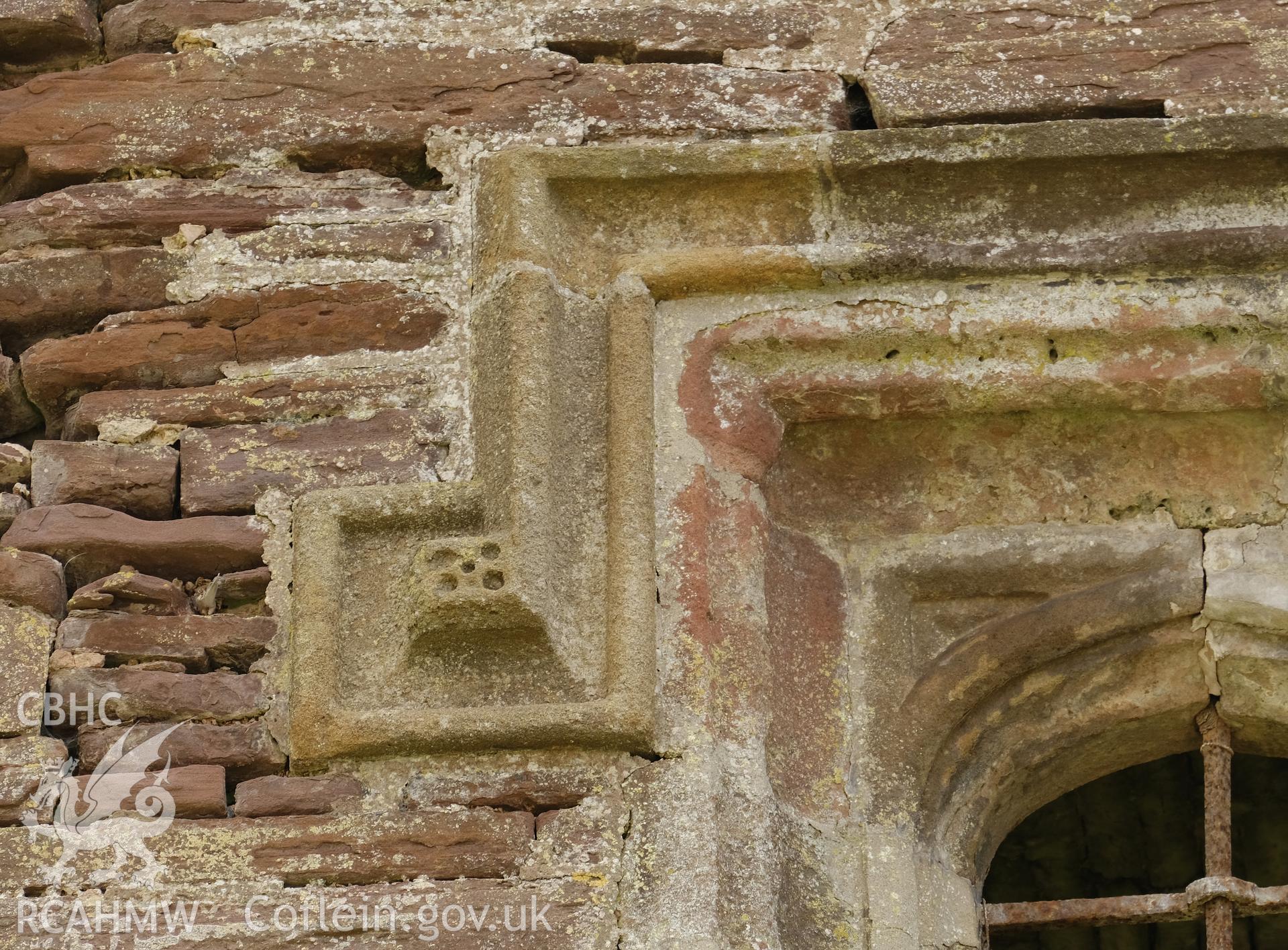 Colour photograph showing Great Porthmel Gatehouse - left-hand label stop in upper stage window, NW front. Produced as part of Historic Building Recording for Great Porthamel Gatehouse, carried out by Richard Hayman, April 2021.