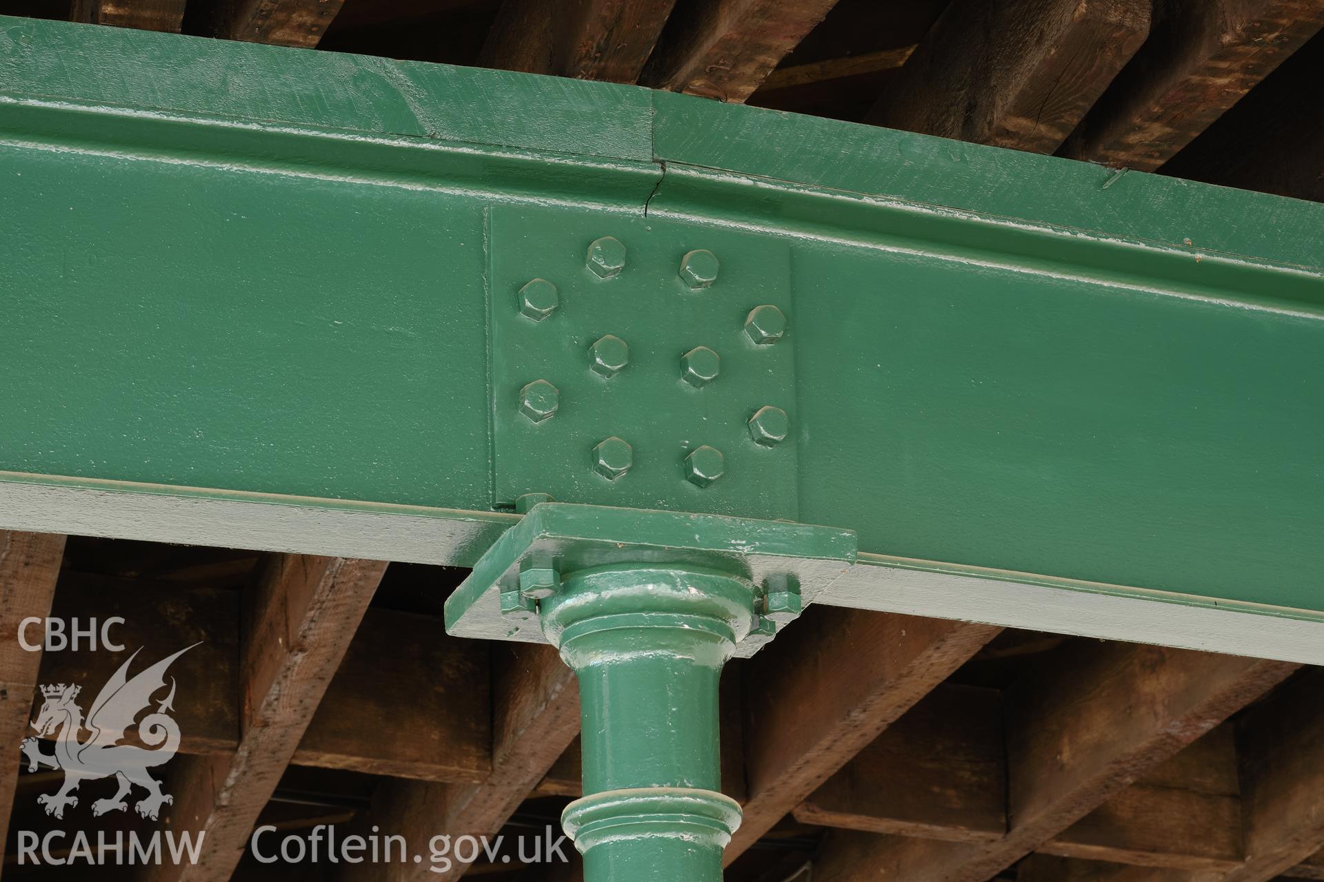 Colour photograph showing Automobile Palace - room 1.1, detail of cast iron post and steel beam. Produced as part of Historic Building Recording for Automobile Palace, carried out by Richard Hayman, June 2021.