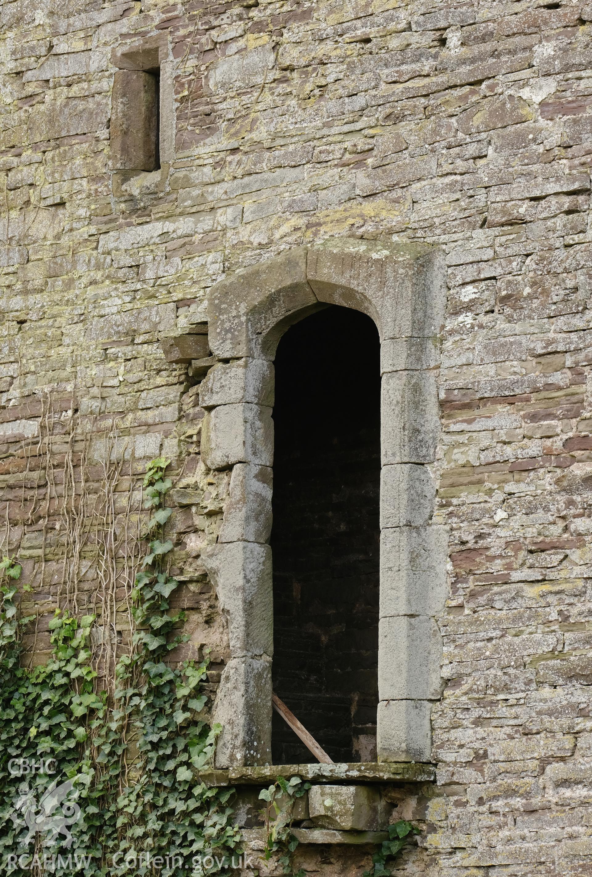 Colour photograph showing Great Porthmel Gatehouse - NE front, doorway to former wall walk and stair light, looking S. Produced as part of Historic Building Recording for Great Porthamel Gatehouse, carried out by Richard Hayman, April 2021.