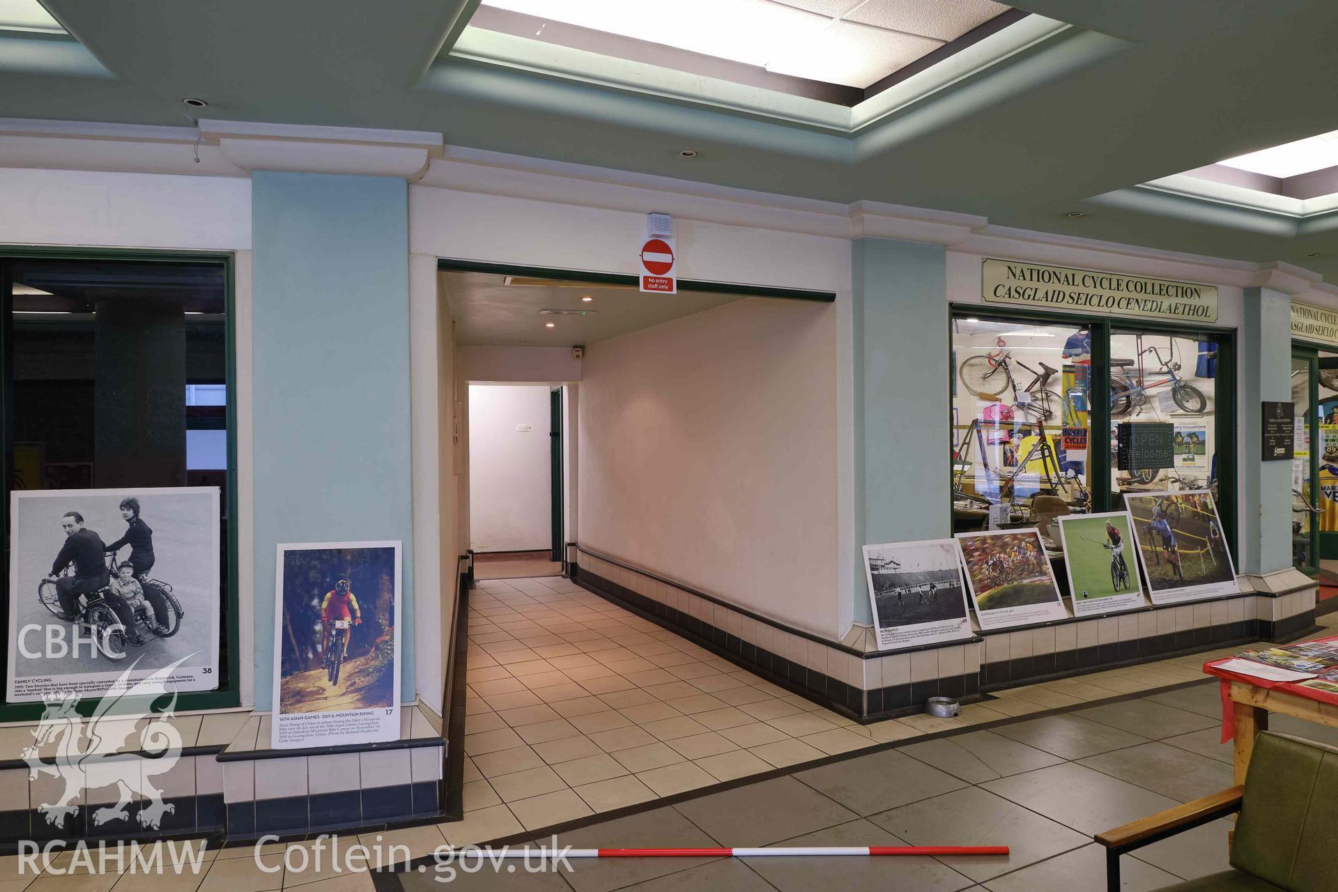 Colour photograph showing Automobile Palace - room G.3 to G.10 (toilets corridor), looking SE. and National Cycle Collection exhibits. Produced as part of Historic Building Recording for Automobile Palace, carried out by Richard Hayman, June 2021.