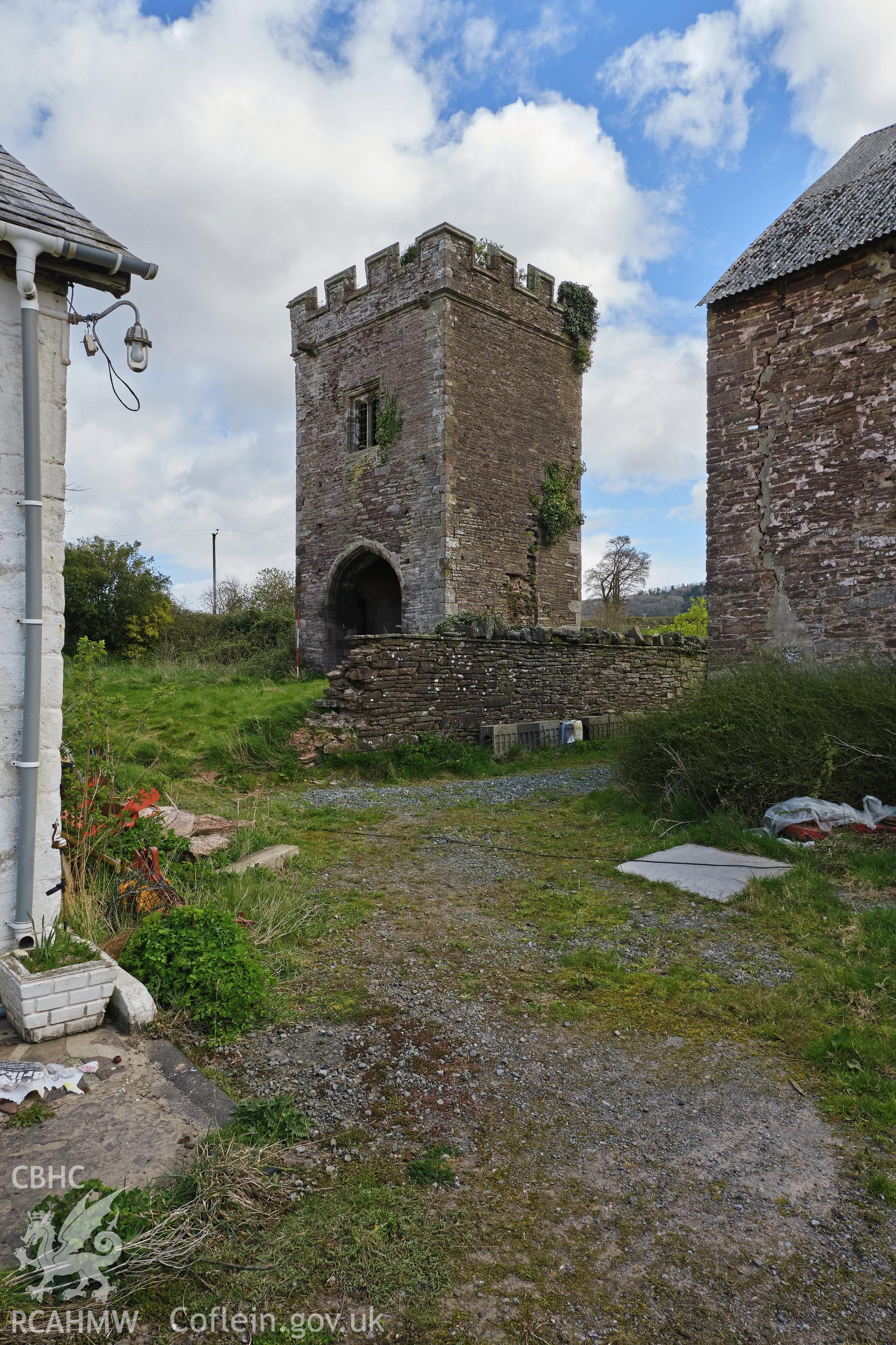 Colour photograph showing Great Porthmel Gatehouse - from farmyard, looking NE with breached garden wall. Produced as part of Historic Building Recording for Great Porthamel Gatehouse, carried out by Richard Hayman, April 2021.