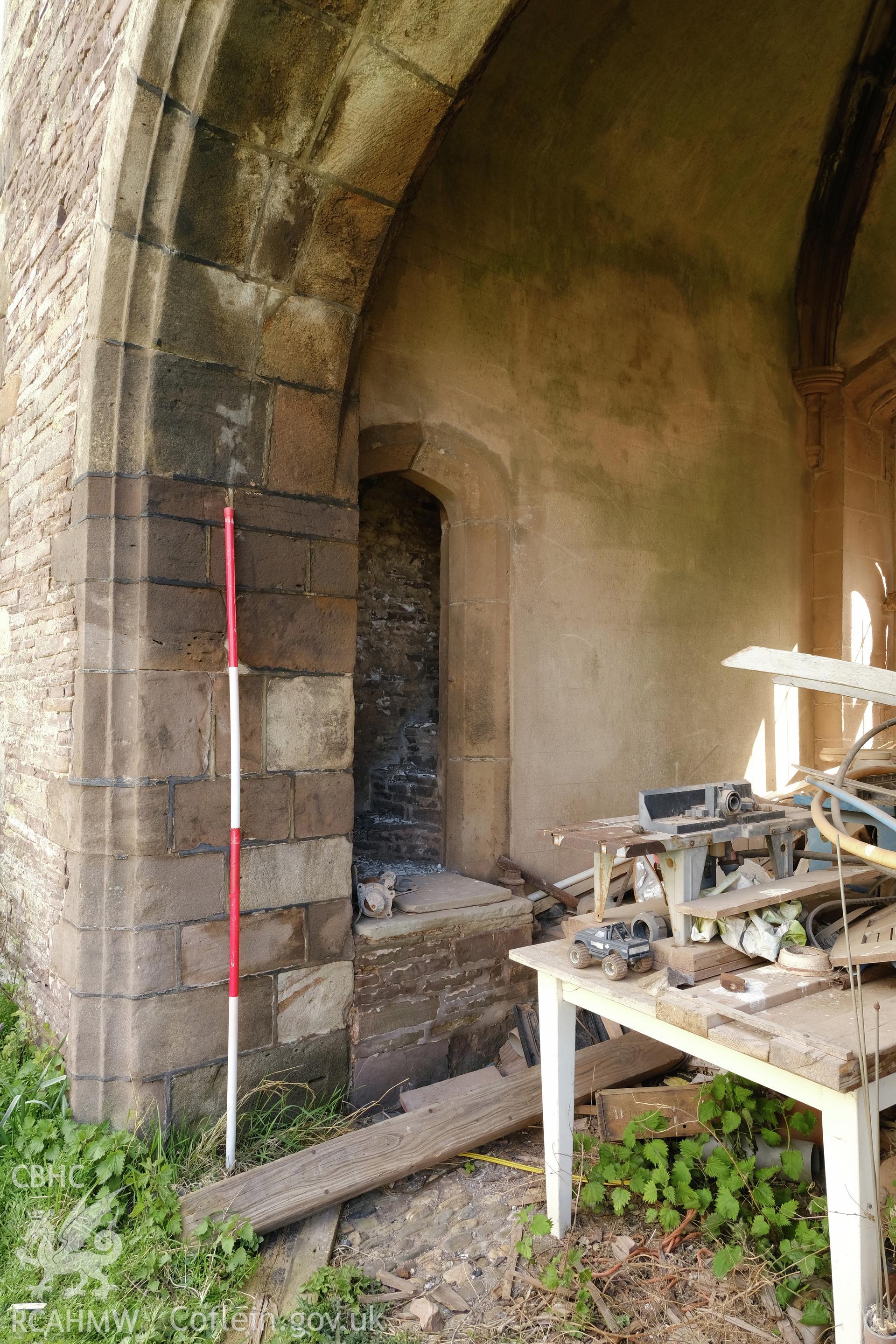 Colour photograph showing Great Porthmel Gatehouse - through passage, with stair doorway, looking NE. Produced as part of Historic Building Recording for Great Porthamel Gatehouse, carried out by Richard Hayman, April 2021.