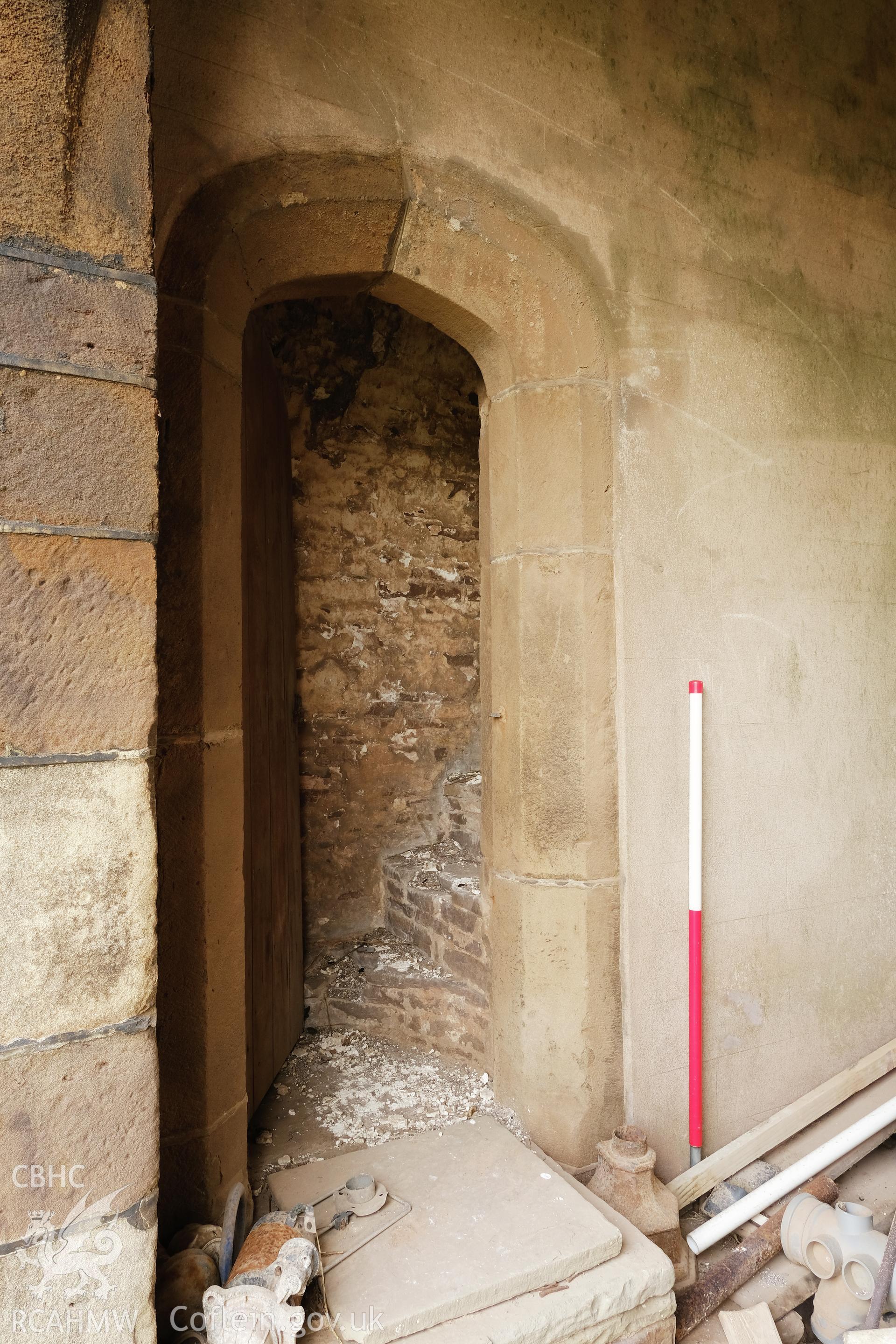 Colour photograph showing Great Porthmel Gatehouse - doorway to stair from passage, looking NE. Produced as part of Historic Building Recording for Great Porthamel Gatehouse, carried out by Richard Hayman, April 2021.
