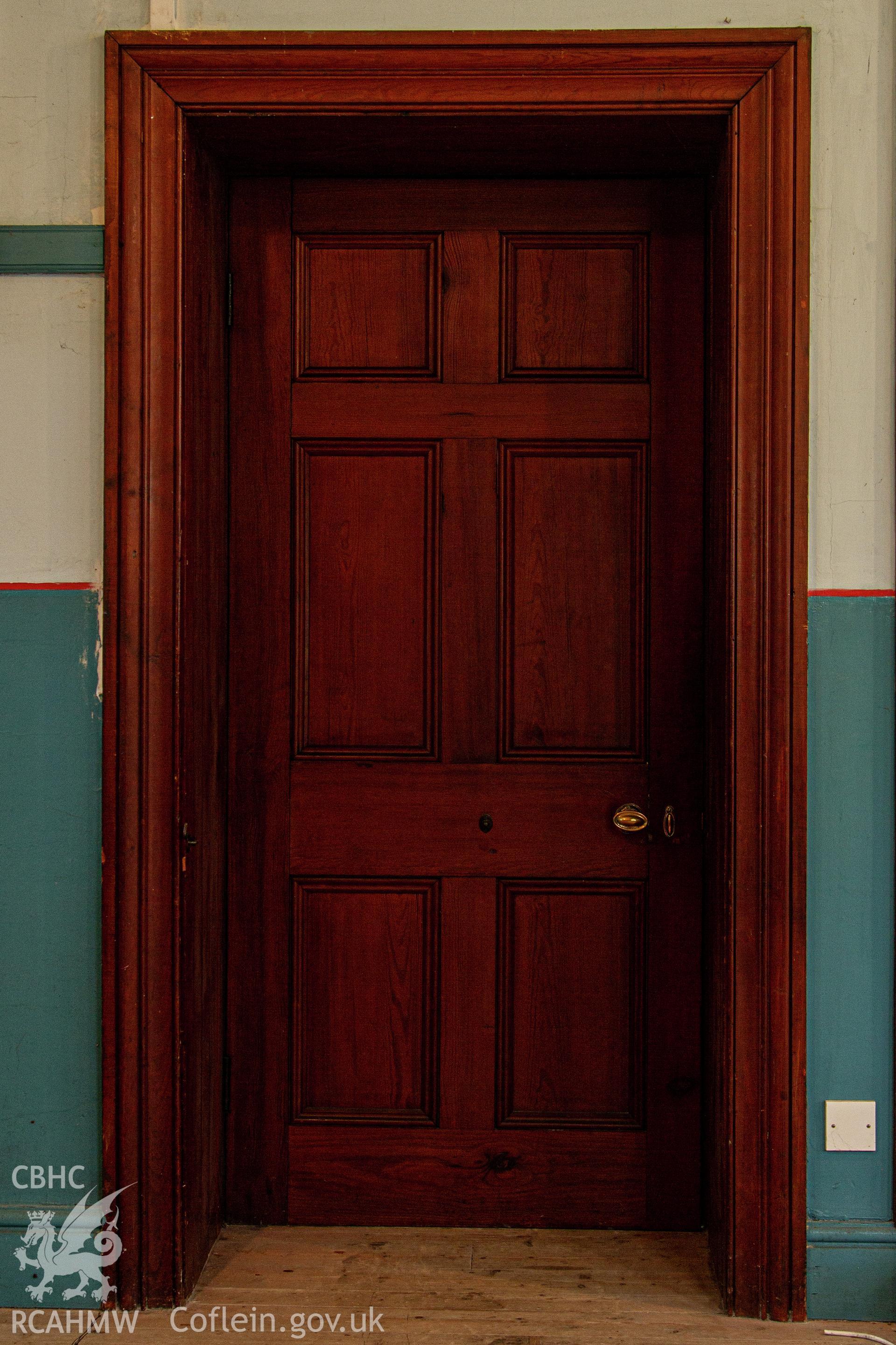 Colour photograph of door from vestry into chapel - part of a photographic survey of Bethania Chapel, Aberangell, Gwynedd, produced for John Linden by Adrian John Hexter as a condition of planning consent. (Planning Application Ref. No. NP5/74/L319). Snowdonia National Park Planning Authority.