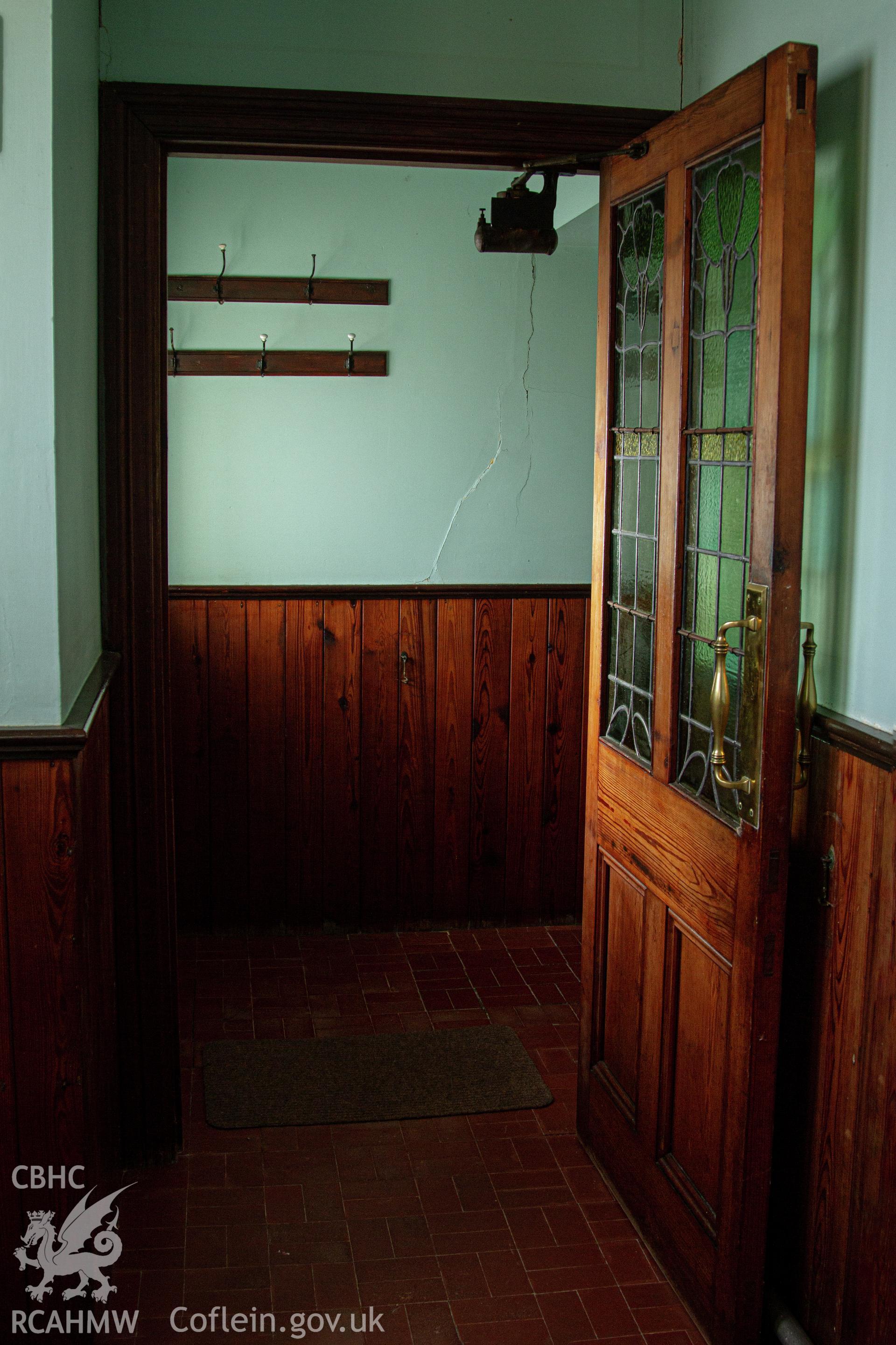 Colour photograph of glazed door entrance from entrance hall to inner entrance hall - part of a photographic survey of Bethania Chapel, Aberangell, Gwynedd, produced for John Linden by Adrian John Hexter as a condition of planning consent. (Planning Application Ref. No. NP5/74/L319). Snowdonia National Park Planning Authority.