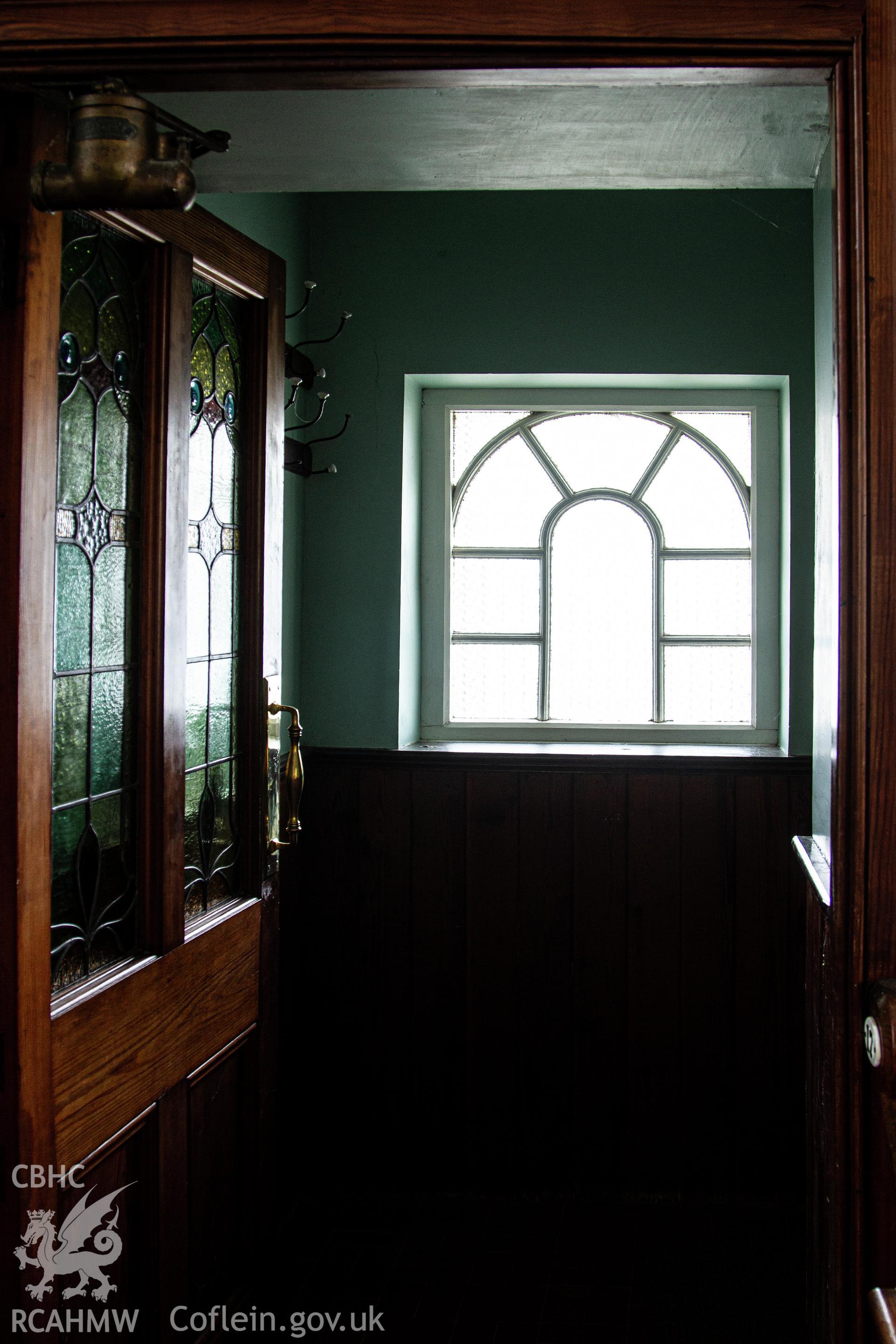 Colour photograph of doorway from chapel, looking through to window in entrance hall - part of a photographic survey of Bethania Chapel, Aberangell, Gwynedd, produced for John Linden by Adrian John Hexter as a condition of planning consent. (Planning Application Ref. No. NP5/74/L319). Snowdonia National Park Planning Authority.